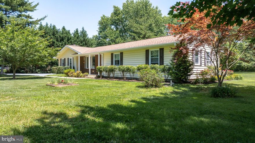 Welcome to this well-maintained, single-level home in the desirable waterside community of Queen Anne Acres, off Greenwood Creek. This property offers 3 bedrooms and 2 bathrooms on a spacious 1.2+/ acre lot with beautiful landscaping. Outside, a BAT Septic system was installed in 2021, and the roof was replaced with a GAF system in 2016. Inside, you'll find hardwood flooring, updated trim and double-pane replacement windows throughout. The spacious family room with modern stone fireplace is perfect for entertaining or relaxing in a cozy corner with a good book. Renovated in 2018, the custom kitchen includes stainless steel appliances, contemporary quartz countertops offering ample prep space, walk-in pantry, laminate flooring and soft close drawers. From the kitchen, step onto the large composite deck (2019) with plenty of space for a hot tub and al fresco dining. The property also includes a 1-car garage with storage space and separate utility shed. Ideally located less than 6 miles to Ocean Gateway and just 15 minutes to shopping centers and local waterfront restaurants, this home combines comfort and convenience in a peaceful, scenic setting.