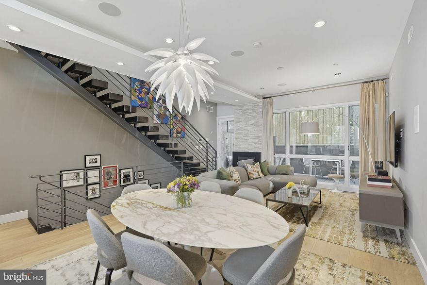 Welcome to 204 W Laurel Street, a home of architectural precision and elevated living in the heart of Northern Liberties. Nestled within Laurel Court, an intimate community of thoughtfully designed residences, this expansive 3-bedroom, 3.5-bath townhome spans over 2,800 sq ft and offers rare amenities including a roof deck, balcony, private rear patio, and parking for one car. The custom kitchen is a chef’s dream with Thermador appliances, quartz countertops, under-cabinet lighting, and a designer backsplash, flowing seamlessly into a sunlit living room with a gas fireplace and access to the deck. Upstairs, two spacious bedrooms with generous closets share well-appointed hall bath and laundry rooms. The palatial primary suite crowns the third floor with soaring 10’ windows, a walk-through closet, and a spa-inspired bath featuring an oversized shower, soaking tub, and dual vanities. The rooftop level is built for entertaining with a wet bar, powder room, and storage leading to panoramic views. Hardwood floors, recessed lighting, solid-core doors, dual-zone HVAC, and oversized windows enhance every detail. With time remaining on the tax abatement, this is a rare opportunity to own an exceptional home in one of Philadelphia’s most desirable communities.