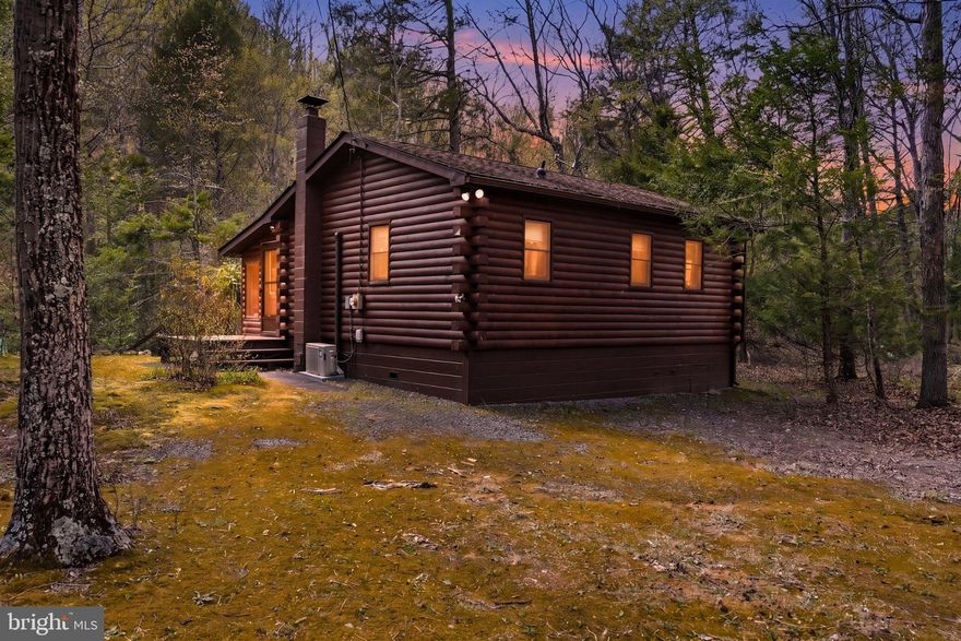 Come enjoy the sound of Twins Falls while sitting in your sunroom overlooking the swimming hole of Meadow Branch Stream.

What could be any better than being on over 6 private wooded acres with the sound rushing water coming from every window.  It's like being at the beach but only in the mountains, the best of both worlds.

This 2 bed 1 bath cabin has been extremely well maintained and is turn key. All furniture conveys, so just move on in and leave all the worries of the big city behind. Would make an ideal Air Bnb. Schedule you showing today!