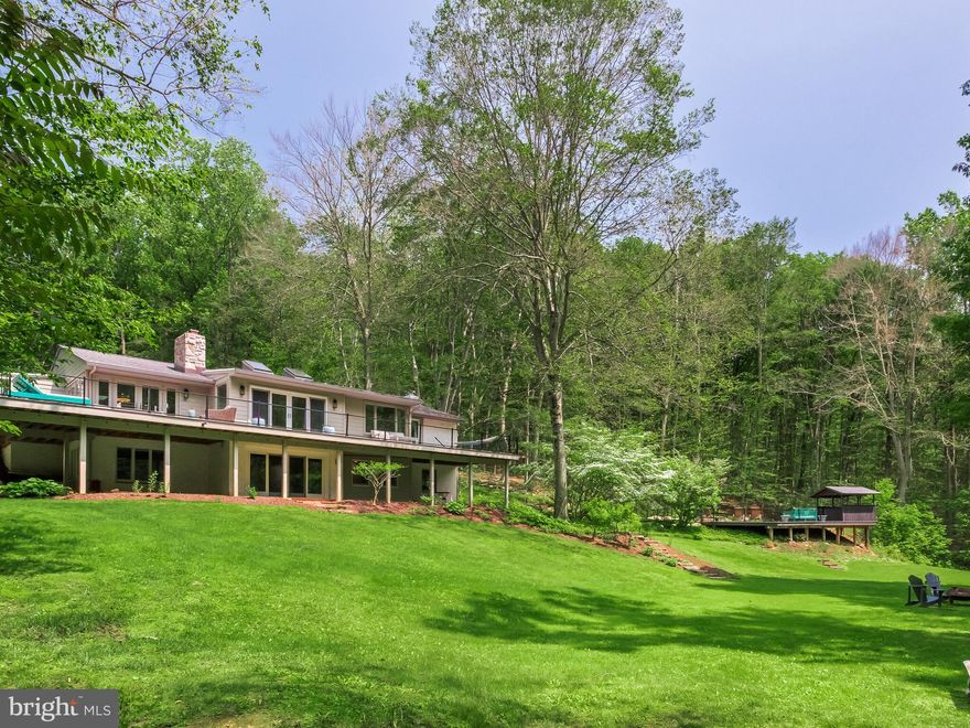 Welcome to this stunning 4-bedroom, 3 full bathroom single-family home nestled in the tranquil and picturesque setting of West Vincent Township, within the highly regarded Owen J. Roberts School District. Set far back from the road and tucked away on a breathtaking 7.2-acre estate, this property offers unmatched privacy, natural beauty, and a lifestyle of peaceful luxury.

Surrounded by mature woods and rolling landscapes, the grounds feature a harmonious blend of open, sun-dappled clearings and enchanting wooded areas that change beautifully with the seasons. A gentle stream winds through the property, adding to the sense of serenity and offering a peaceful soundtrack to daily life. Whether you envision nature walks along your own private trails, gardening, outdoor entertaining, or simply enjoying the stillness of the countryside, these 7.2 acres provide the perfect backdrop for your dream lifestyle—all while being just minutes from local amenities.

Step through the foyer into a warm and inviting great room featuring gleaming hardwood floors, a beautiful stone fireplace, and an abundance of natural light from skylights and sliding doors that lead to a large, wrap-around deck overlooking the serene landscape.

The gourmet kitchen is a chef’s dream, thoughtfully designed for both everyday living and elegant entertaining. It showcases luxurious granite countertops, rich custom cabinetry that offers abundant storage, and a generous center island with a prep sink—perfect for meal preparation or casual gatherings. A charming bay window seat invites relaxation with morning coffee or afternoon reading, while natural light floods the space. Culinary enthusiasts will appreciate the top-of-the-line appliances, including a custom paneled refrigerator, a powerful six-burner propane cooktop, and double ovens that make hosting a breeze. The adjoining butler’s pantry enhances functionality with additional storage, counter space, and seamless access to the attached two-car garage—ideal for unloading groceries with ease.  The dining area offers charm and functionality with a second stone fireplace and direct access to the deck—perfect for indoor-outdoor entertaining.

The main level also features a luxurious primary suite with hardwood floors, built-ins, a fireplace, and private deck access. The renovated en-suite bath boasts a marble-tiled glass shower, soaking tub, double marble vanity, and in-suite washer/dryer. A second bedroom and full hall bath complete the main floor.

The lower level offers even more living space with a bright family room, brick fireplace, and walkout access to a brick patio and expansive backyard. Two additional bedrooms with walk-in closets, a beautifully renovated full bath, and a mud/potting room with outdoor access make this level ideal for guests or multi-generational living.

Step outside to experience resort-style living in your own backyard. At the heart of the outdoor oasis is a luxurious heated saltwater in-ground pool, offering a spa-like swimming experience with low-maintenance benefits and a softer, more natural feel. Surrounding the pool is an expansive lounge deck, ideal for sunbathing or hosting summer gatherings. A covered pool cabana with space for a bar or grill provides a shady retreat for relaxing or entertaining guests in style. Lush landscaping, mature trees, and the tranquil sounds of the nearby stream enhance the atmosphere, creating the ultimate private escape.

This is a rare opportunity to own a secluded, amenity-rich property in a prime location. Whether you're seeking a peaceful retreat, an entertainer’s paradise, or a family-friendly haven, this property delivers it all—don’t miss your chance to make it yours!