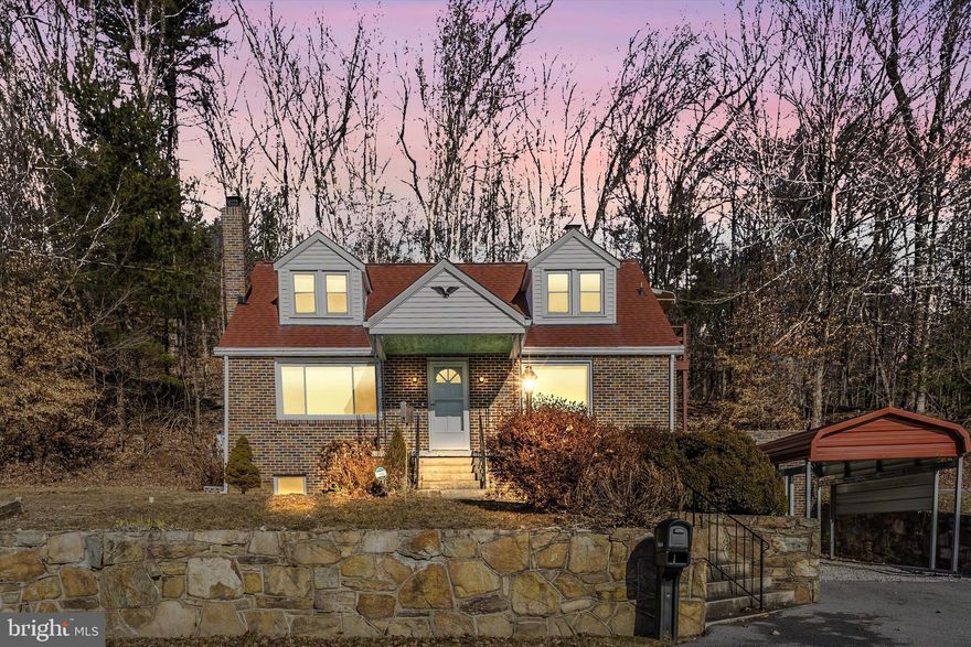 Nestled on 2.87 wooded acres, this charming brick Cape Cod offers breathtaking views and a perfect blend of vintage character and modern updates. Step into the delightful retro kitchen, where ample space, updated flooring, and a picturesque window create a warm and welcoming atmosphere. The spacious living room invites you to unwind by the gas fireplace with variable flame height and variable fan speed and a  beautiful stone surround, while another large picture window frames the stunning scenery outside. With two bedrooms and a full bath on the main level, plus two additional bedrooms and a second full bath upstairs, this home offers both comfort and versatility. Hardwood floors add timeless charm throughout, while thoughtful updates—including a 2018 HVAC system (heat pump with oil backup) and a 2015 roof—ensure peace of mind. Enjoy outdoor relaxation on the patio, store your essentials in the one-car garage, and appreciate the tranquility of nature while still being just minutes from Rt. 15. If you're looking for a home that combines classic appeal with modern conveniences and a truly picturesque setting, this is the one!