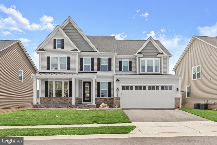 Truly exceptional NV Homes Longwood model in desirable Maple Lawn South, only five years young. This home features a top upgrade front elevation, adding two extra feet to the front bedroom, dining room, and lower-level exercise room. Pristinely maintained, it offers unparalleled top-of-the-line upgrades. A covered front porch greets you, enhanced with custom limestone slabs and an exquisite stone feature. Inside, the remarkable open floor plan spares no expense with hand-scraped hardwood flooring throughout the main and upper levels and custom window treatments, including top-down/bottom-up light filtering shades. The stunning chef-inspired kitchen highlights Quartz counters, a decorative tile backsplash, a gas cooktop, a center island, Restoration Hardware pendant lighting, double wall ovens, and a large custom Closet America walk-in pantry. The adjoining breakfast area and family room feature a custom Pella 14' stackable slider with three 4’5” glass panels and three custom light-filtering motorized shades. Relax on the screened porch, showcasing a stone gas-burning fireplace, a 55” TV, two app-controlled ceiling fans, Sonance outdoor speakers, custom lighting, and custom sunshades. There is also an open deck area with a hose bib and custom lighting. The main level includes a formal dining room, an optional fifth bedroom or office, a full bathroom with tile to the ceiling, custom frameless shower doors, and an arrival center. Upstairs, the sprawling primary suite is adorned with a custom ceiling fan, two custom Closet America walk-in closets, a tray ceiling, custom room darkening shades, and crown molding. The luxury primary bath features upgraded cabinetry and tile, a free-standing soaking tub, dual vanities, and an oversized double-head shower with tile to the ceiling. Three additional bedrooms each have a ceiling fan, room darkening custom window treatments, a walk-in closet, and all en suite baths with Delta Vero faucets and accessories. The upper level also includes a laundry room with a Whirlpool front-load washer and dryer on pedestal drawers. The phenomenal lower level features a recreation home theatre room with darkening custom window treatments, a custom bar with a mini fridge and dishwasher, an exercise room, a full bath with tile to the ceiling and a custom frameless shower door, additional storage, and walkout-level access. It includes a new Pella Narrowline slider and commercial-grade LVP flooring. The beautiful, covered patio features a dry ceiling, Techo Bloc high-end Para slab pavers, a custom Techo Bloc custom gas fire pit, two app-controlled ceiling fans, eight recessed lights on dimmers, Sonance outdoor speakers, a wireless access point, a 65” TV, a Dove Canyon hot tub, and custom landscape lighting. Additional features include an alarm system with extra smoke detectors and water leak sensors, pull-down attic stairs to the furnace, a radon system with a fan, Tech Bloc edgers with beautiful stones and boulders, and landscape lighting in the front with four pathway lights leading to the side gate. The whole yard has an app-controlled irrigation system. The custom-painted garage features Swisstrax flooring, Garage Experts slat walls, custom cabinets, and a newly installed insulated Clopay garage door with a whisper-quiet side mount motor. Upgraded solid wood stairs with direct-set metal pickets allow for a wider stairway to the 2nd floor. The mechanical room includes a new GE side-by-side fridge with a water hook-up. Generac Whole House Generator installed on a custom Techo Bloc base to match the patio. Walk to the 3 schools from your community, Fulton Elementary, Lime Kiln Middle, and Reservoir High. This home offers everything you have been searching for and so much more!