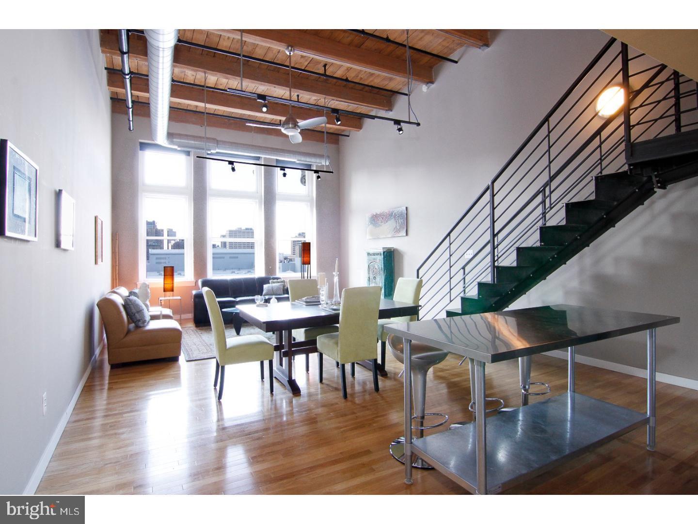 **Contact Listing Agent or Richard for information**
Step into the heart of Center City living at 1027 Arch Street Lofts, nestled within the historic Pitcairn Building. This captivating sixth-floor unit unveils a contemporary bi-level New York loft design with beautiful unobstructed views of the Philly skyline!! Boasting two bedrooms. two baths, and in unit laundry. Upon entering, you'll immediately notice the hardwood floors, exposed wood beams, and ceilings that soar to an impressive 20 feet, while towering windows flood the space with natural light, framing panoramic views of Philadelphia's iconic skyline. On the main floor, discover a spacious coat closet, a luxurious marble bathroom with a custom sink and jacuzzi tub, and a guest bedroom with sleek bi-fold doors. The in-unit laundry room, complete with washer/dryer, adds practicality to your daily routine. The upgraded kitchen dazzles with stainless steel appliances, granite countertops, and a custom island featuring an integrated wine cooler—perfect for both entertaining and storage. The expansive living room is highlighted with its lofty ceilings and industrial-inspired lighting. Walk up to the second level to find the another bedroom, adorned with an oversized closet and an ensuite bathroom boasting marble finishes and a custom shower. Additional storage space is cleverly built off the extended bathroom area. Residents enjoy access to a secured mail room in the lobby, bike storage in the basement, and the option to lease additional storage within the building. Embrace the pet-friendly building ideal for an owner occupant or long-term rentals, catering effortlessly to students, hospital employees, and young professionals alike. Convenience reigns supreme with a walk score of 99%, placing Jefferson Train Station, public transportation, and nearby parking garages within easy reach. Indulge in the vibrant culinary scene of Chinatown and Reading Terminal, explore the nearby Trader Joe's, or unwind and shop at the Fashion District Philadelphia—all just steps away from your doorstep. Nearby parking options available for those who need it. Schedule your showing today! Unit is larger than assessed size, actual square footage approx 1300 sq ft. **Listing agent’s family member has financial interest in the property**