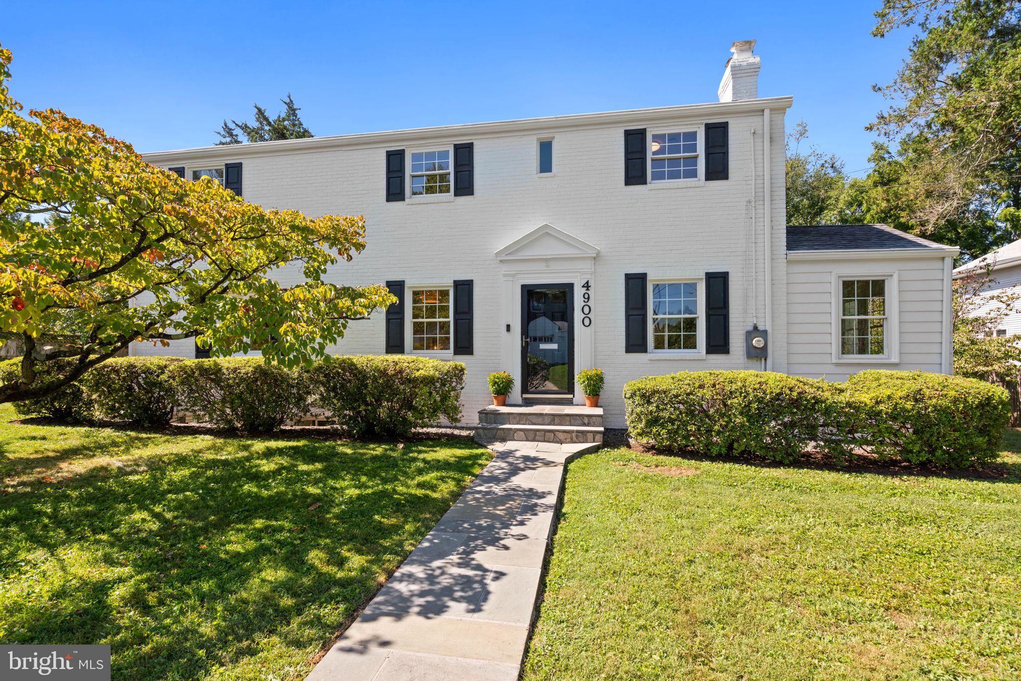 Located in delightful Westgate, known for its wonderful community and its extremely convenient location, this classic four bedroom, three-and-one-half bath white Colonial enjoys 3,650+/- square feet of living on three levels, plus a finished loft above the detached garage. A distinguished patio with a firepit and an idyllic pergola, as well as a rear deck, and front and backyards, create the perfect settings for gathering with family and friends. Mature bushes flank the manicured front yard and handsome flagstone walkway.
A center-hall foyer opens to both the elegant dining and living room, which enjoys a handsome fireplace. There is a sun-filled study and a separate den, creating ideal relaxation and home work spaces. The functional kitchen is adjacent to both a sun-drenched breakfast room with a beautiful bay window, as well as the spacious family room, adorned with soaring beamed ceilings, a fireplace, and access to the back deck. A lovely powder room is tucked away for the utmost convenience. The second floor of this quintessential home boasts the primary bedroom featuring an en suite full bath, dual closets including a walk-in, along with two additional bedrooms and a full bath. There is a plethora of storage, including a large unfinished space, as well an attic above.
The lower level provides a spacious recreation room, the fourth bedroom and another full bath, a private outdoor entrance to a purposeful mudroom, as well as laundry, a workshop, and additional storage. Other amenities include a detached two-car garage with a finished loft above, and a private driveway. 4900 Montgomery Avenue is close to the Little Falls Club pool and tennis courts, the playground and fields of Westbrook Elementary School, and the Capital Crescent Trail, yet it maintains the advantages of urban living. This beautiful home is just steps to Friendship Heights, Westbard Square, Spring Valley shops and restaurants, and major transportation routes. Westbrook, Westland, B-CC schools serve the neighborhood.