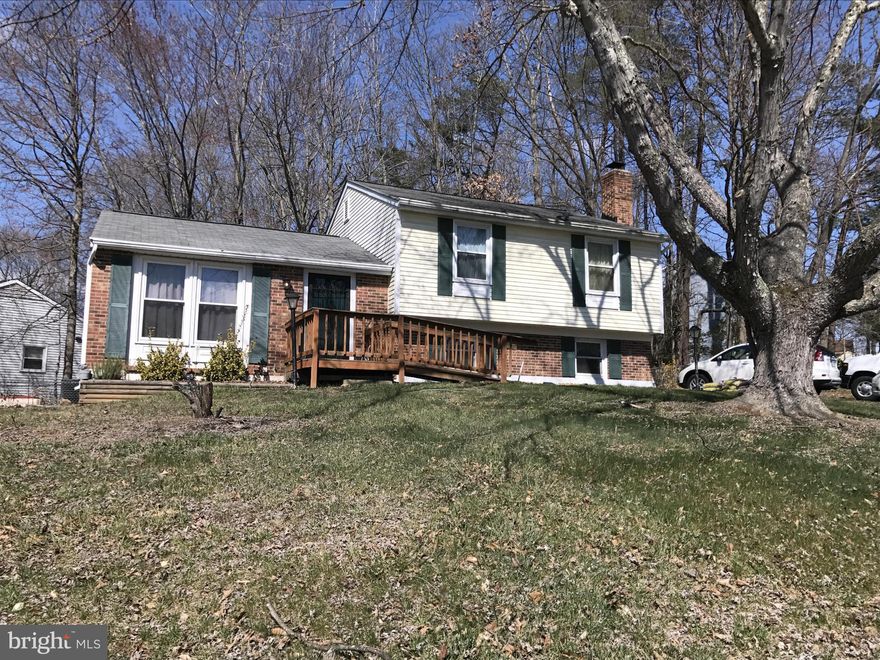 Adorable split level home in North Stafford. Convenient location close to schools, shopping, restaurants, commuter services & Quantico.  Updated kitchen w/ new corian counters, new appliances, new tile floor, new cabinets & tray ceiling. Master bath w/ new granite vanity. 1/2 bath w/ marble vanity & tile floor. Brick hearth w/ wood stove insert in FR. DR walks out to deck & fenced yard. New HVAC.