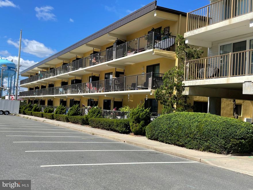 This exquisite Ocean-block, 1 bedroom, 2 bath condo is a tranquil seaside retreat that offers the perfect blend of coastal elegance and modern convenience. With beautiful views of the Atlantic Ocean from its private balcony, this Ocean City property is a haven for those seeking a beach convenience lifestyle. Upon entering, you'll be greeted by a soothing and neutral coastal color palette that sets the tone for a relaxed and inviting atmosphere. The condo boasts an open-concept design, seamlessly blending the living, kitchen, and dining areas into one open and airy living space. Sunlight streams through the large glass sliding door, illuminating the interior and enhancing the serene coastal ambiance. Step out onto your private balcony to savor the mesmerizing ocean block views and endless horizon. Whether it's morning coffee or sunset cocktails, this balcony offers an ideal spot to unwind and enjoy the ocean breeze. The kitchen is complete with a breakfast bar island, and ample cabinetry. It's perfectly designed with an open connection to the living and dining areas. The spacious bedroom is a serene oasis. Featuring separate vanity in the bedroom and attached full bath.  It provides a restful sanctuary after a day of beachfront adventures. The condo has another full bath unlike other condos in the area with a 1 bedroom. The full tub/shower bath is  located on the hall convenient for guests. Not to mention this building is a concrete structure. For added convenience, this condo is being sold furnished,(excluding bed) making it turnkey for your immediate enjoyment and rental potential. Outdoor features for your convenience are bike racks and outdoor shower to swiftly remove sand. Not to mention the park like grill!  Experience the epitome of coastal living in this tastefully designed condo with ocean views. This unit offers 1 parking space and additional space shared. Don't pass up this unique find!