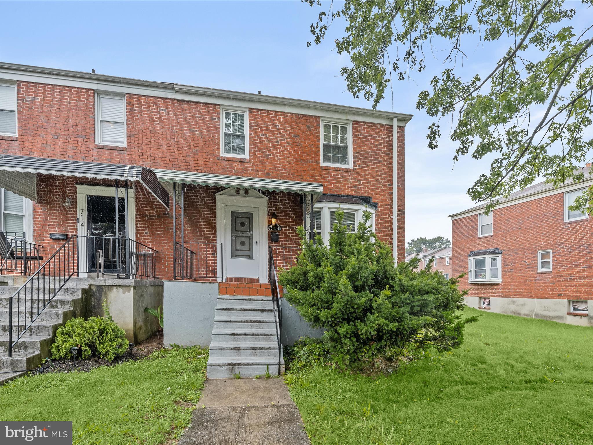 FREE MONEY AVAILABLE ... $10,000 GRANT MONEY IS AVAILABLE ON THIS HOME !!! The home located at 714 Stamford Road in Baltimore, MD 21229 is a charming brick end-of-row townhouse situated on a corner lot in the West Hills neighborhood. Built in 1954, this Colonial-style residence offers approximately 2,112 square feet of living space and features five bedrooms, two full bathrooms, and one half-bath. The main level includes a spacious living room with hardwood floors, a separate dining area, and a kitchen equipped with updated appliances and a tile backsplash. Upstairs, there are three bedrooms and a full bath, while the fully finished lower level provides two additional bedrooms, a second kitchen area, and a family room. A walk-up attic adds extra storage. Outdoor amenities include covered front and rear porches, a fenced backyard, and a patio, offering ample space for entertaining or relaxing. The home also includes a driveway and access to street parking. With forced air heating, central air conditioning, and public water and sewer services, this home combines comfort and convenience