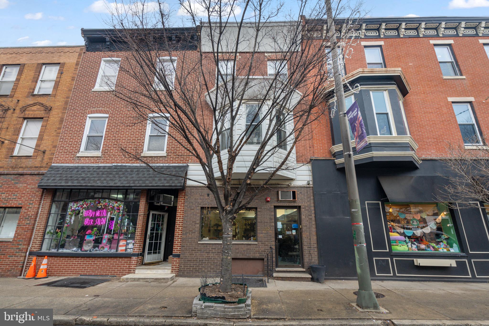 PRIME REAL ESTATE ALONG EAST PASSYUNK AVENUE! Located along the bustling East Passyunk Avenue corridor in the Passyunk Square neighborhood! This property extends street-to-street and has access from the rear on Tasker St as well as frontage and access on East Passyunk Avenue. Currently being operated as a Veterinarian office on the first floor with access to the unfinished basement with all mechanical systems. The 2nd/3rd floor is a large 3 bedroom, 1.5 bathroom apartment that is currently leased. Large living room and kitchen as well in the unit. The apartment is massive! Like a house. The only access to the apartment is through the commercial space. There are no separated entrances. Currently the apartment has to walk through the 1st floor commercial space to get into their unit. There is also only one heater for the whole building. Utilities are only partially separated. Lots of potential here! Preference is to sell the practice with the real estate. Open up your own business...take over an existing business...or buy and hold as your next investment! Potential to also live above and rent the downstairs! The opportunities are endless! Make your appointment today! This is a unique property in a bustling location. Won't last for long! Property is being sold in "AS-IS" condition.