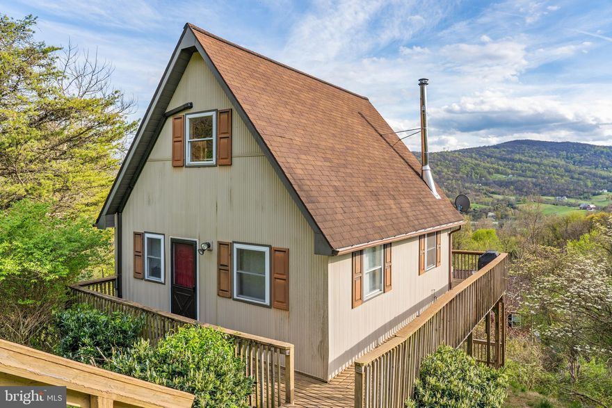 Charming and Cozy 3 level Chalet with dramatic mountain views close to all the area has to offer. Wineries, breweries, restaurants, hiking, kayaking, cycling and much more.  Many updates in the last few years including new windows/doors , sliders, heating and cooling system, paved driveway, water treatment system. Other features include; warm wood stove. loft area, main floor bath and bedroom, deck off kitchen /family room.  Lower level has rec and utility rooms with a rear entrance with storage shed under the deck. Located in Apple Mountain Lake with lots of great amenities including basketball courts, beach, lake, picnic area, tennis courts, playground and more..  Great access via 66 and US 55 between Marshall and Front Royal.