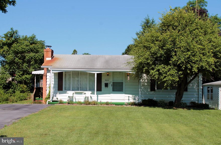This charming well kept home is ready to welcome it's new owners.  The home offers plenty of outdoor entertaining and living space, including a well landscaped 0.23-acre yard, front covered porch, side covered porch and large screened-in rear deck.  You'll find plenty of storage space in one of three outdoor storage sheds.  Two situated at the rear of the yard and one attached to the home.  Step through the front door and you'll find a spacious living room complete with large front bay window and cozy brick wood burning fireplace.  The fireplace is made more efficient thanks to the wood stove insert, sure to offset heating bills during winter months.  The kitchen offers table space to seat 4 comfortably, lots of counter space, separate pantry, double sink and appliances.  There plenty of space to spread out when cooking for one or a crowd with the amount of counter space offered.  The Anderson sliding glass doors floor the kitchen with morning sunlight and offer easy access to the screen deck for morning coffee without the bugs.  The main level offers 2 spacious bedrooms and one full bath.  One bedroom offers exposed hardwood floors and the other currently has carpet over hardwood floors.  The bath includes storage space, oversized single vanity and a one piece tub/shower combo.  Head down stairs to the finished lower level to find a spacious workshop that is walk-out level to the rear yard.  The workshop includes lots of built-in storage, workbenches and plenty of space for your hobbies or storage.  The lower level also includes a finished family room, den and separate laundry room complete with laundry tub and storage shelving.  The home is equipped with a sump pump, central air, 200 amp electric and replacement windows.  The location is convenient to both I-70 and I-81, perfect for daily commuters.  Schools, shopping, dining options and employment centers are within minutes of the home.  Come see this well cared for home today.