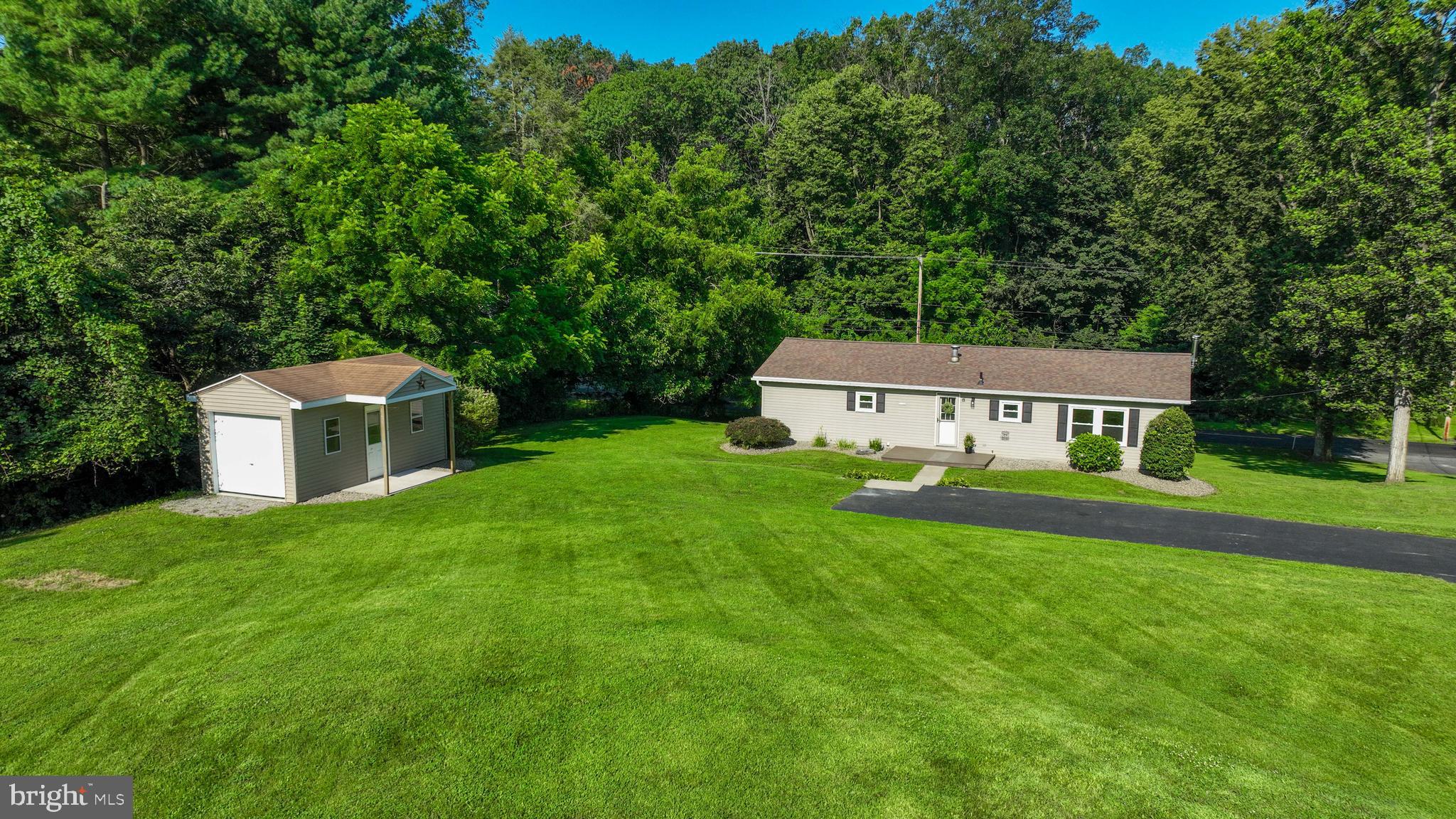 Check out this move in ready rancher situated on nearly 3/4 of an acre with amazing views! Featuring a finished lower level for extra living space! This home offers a bright and open layout with modern features throughout and one floor living on the main level. The kitchen is open to a breakfast area. The kitchen and dining areas flow into the living room that features a sliding glass door leading to the deck. The primary suite offers a walk-in closet and en-suite bath with a walk-in shower. Two additional bedrooms and full guest bath complete the main level. The lower level offers a versatile living space for a family room and rec room. For convenience, a laundry room and half bath are located on the lower level. A storage shed with keypad access and a bay door offers the ability to securely store your tools and equipment. Enjoy the countryside views from the rear deck or the front patio with maintenance-free decking.