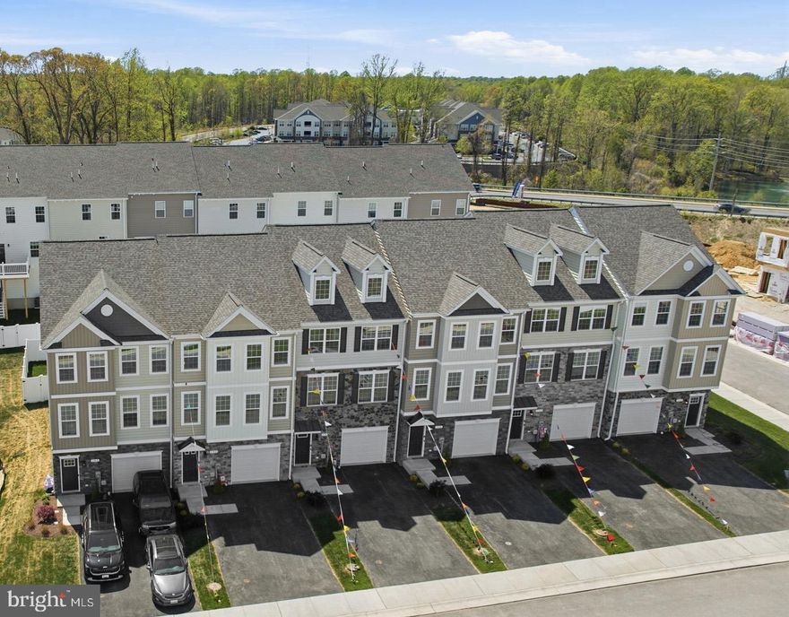 Brand New & Move-In Ready! Experience the quality of a QBHI home without the wait. This stunning interior-unit townhouse in Phase 2 of Patuxent Commons is fully completed and features Numerous premium upgrades selected by a designer trained coordinator.  Located in the heart of Prince Frederick, this home offers ultimate convenience  just a short walk to local dining, shopping, and the public library. Property Highlights: Three Finished Levels  Functional living space designed for modern lifestyles. Entry Level  Oversized garage leads to a welcoming foyer with a custom bench and cubbies. Includes a versatile bedroom/recreation room with a full bath and access to a private, fenced backyard.  Main Level  An open-concept family room flows into an inviting gourmet kitchen featuring upgraded cabinetry, granite countertops, stainless appliances, a walk-in pantry, and spacious  island/ peninsula with overhang  for extra seating. Outdoor Living  Step out from the kitchen onto a maintenance-free deck with added vinyl privacy screening.  Upper Level  The primary suite is a true retreat with a tray ceiling, walk-in closet, and QBHI’s signature "Deluxe Shower" plus a large double vanity with built in seating  area. Two additional bedrooms, a second full bath, and a dedicated laundry room complete this level. 
Builder Incentive: Take advantage of $12,500 toward closing costs when using the builder’s preferred lender and title companies! 
*Note: Interior images are of a similar model; actual finishes may vary. Virtual staging may be shown in some rooms for visualizing the space.  Schedule your tour today!