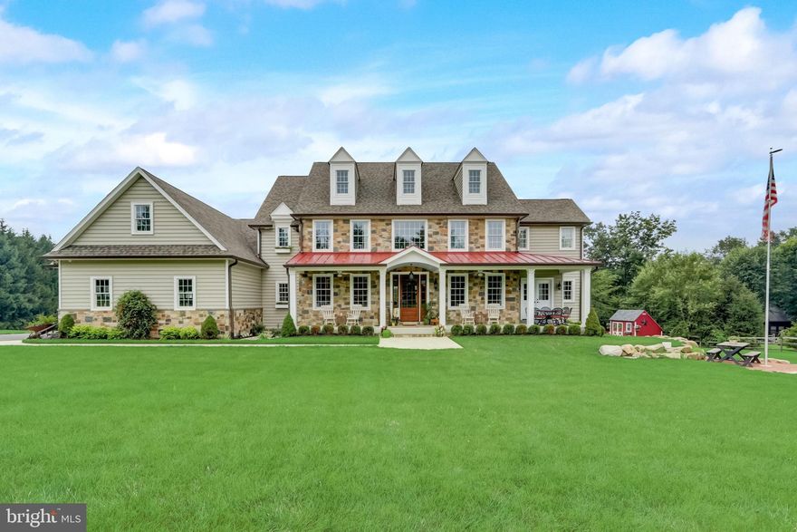 Get ready to be impressed by this McGinn custom build, showcasing exquisite craftsmanship and attention to detail. From architectural features to interior finishes, every aspect is tailored to meet ultra efficiency, comfort, and enjoyment. From the moment you start approaching down the long driveway you appreciate the beauty of the natural stone exterior accents and sprawling front porch with standing seam metal roof.  Enter through the solid mahogany door, you are greeted by a two-story foyer with Juliet balcony and gleaming wide character grade oak wood floors.  Throughout this home you will experience a floor plan that was designed to utilize space effectively for maximum lifestyle. Let’s start in the gathering room which features reclaimed barn wood beams, a cozy Heat N Glo gas fireplace furnished in natural stone surround, a bluestone hearth and wood beam mantle. Moving on, you find coffered ceilings that bring a nice richness to the formal dining room, plus the sunlight through its cottage windows add a warmth to the ambiance. Conveniently located between the dining room and kitchen is the butler pantry hosting one of your three SubZero fridges, a freestanding ice machine, and Nantucket round sink with InSinkErator filtered instant hot/cold water dispenser. The gourmet kitchen is adorned in premium Starmark cabinetry and endless granite counters. Any chef will delight in using the commercial dual fuel range, vent hood insert with make up air system, warming drawer and farmhouse porcelain sink. You won’t run out of prep space here, because there is additionally a fully equipped working pantry. Just off the kitchen is the mud room giving convenience to entry from your day with beautifully crafted individual storage spaces, a quick clean-up laundry station and pet shower. Beautiful dual sliding barn doors lead you into the office, which is a “must have” in every modern day home. To complete the main level is a provisioned space; utilized as a recreation room for today’s need, but set up for an in-law quarter conversion or first floor main bedroom suite. The second floor offers four bedrooms, with each thoughtfully designed to offer both solace and style. Plus, three of the homes full bathrooms,  all equipped with modern features and luxurious finishes. The inclusion of a media room, boasting an 100" screen and 7.1 home theater system, adds an entertainment haven to the home. Whether you enjoy movie nights with family or hosting friends for sports events, this dedicated space is perfect for immersive entertainment experiences. Also found on the second floor is an oversized laundry room with two washer & dryer hook-ups, a waterproof membrane floor system with high capacity drain and is finished in QuietRock sound reducing drywall. Onto the lower level, you will find an area that gives the at-home professional a more private space to conduct business with its own outside entrance, plus houses one of the homes full baths. The rest of this level is an open canvas for you to design. But if you need even more square footage, walk-up to your third level that is fully floored, framed and ready to be finished. Car enthusiasts and those with multiple vehicles will appreciate the generous 4-car garage, accessed through its two 16’ x 9’ insulated doors and rolling onto its polyaspartic epoxy flake floor. To keep all this running and your family out of the dark & cold when in need, is the Kohler liquid cooled whole house generator.  In the rear yard you will find a fire pit that stands out above others with its strategically placed stone boulders and bluestone deck. The location of this picturesque 3-acre lot, allows you to retreat from the hustle and bustle of everyday life while enjoying the beauty of the surrounding natural landscape. Overall, this home combines distinctive design, high-end features, and the natural beauty of the outdoors, creating a truly exceptional living experience.