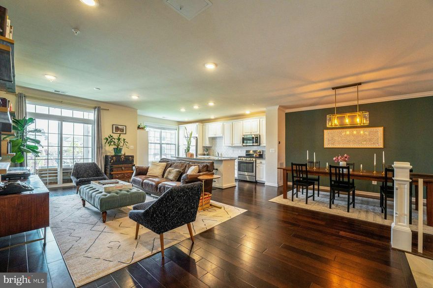 Step into this beautifully maintained 2-bedroom, 2.5-bath condominium, where thoughtful design and quality craftsmanship come together seamlessly. The open-concept great room welcomes you with rich hardwood floors, beautiful custom floating shelves and effortless access to a charming, covered porch — the perfect spot for morning coffee or unwinding at the end of the day.  At the heart of the home, the kitchen truly shines. Crisp white cabinetry, granite countertops, a stylish backsplash, and a spacious center island create an inviting space ideal for both everyday living and easy entertaining. A convenient powder room completes the main level.  Upstairs, the primary suite offers a peaceful retreat with its private en-suite bath and generous walk-in closet. The secondary bedroom is equally spacious and enjoys access to a well-appointed hall bath. A versatile upper landing provides the perfect nook for a home office, and the washer and dryer are thoughtfully located on the bedroom level for added convenience.  Perfectly situated between Brambleton Town Center and the Ashburn Metro Station, this home offers unbeatable access to shopping, dining, and major commuter routes. Residents enjoy a beautifully landscaped community filled with resort-style amenities, including three clubhouses, multiple pools, party rooms, fitness centers, basketball and tennis courts, and scenic walking trails. With close proximity to Dulles Airport and key commuting corridors, this home blends comfort, convenience, and an exceptional lifestyle.  Don’t miss the opportunity to make it yours.  **** Front door access to #103 faces Stuarts Glen Terr*****