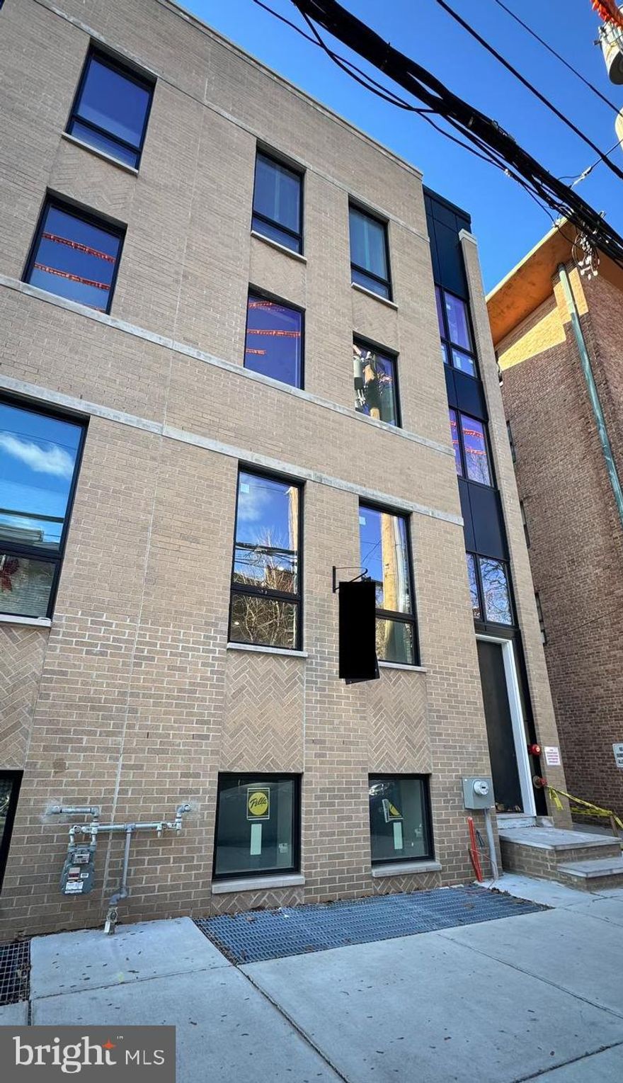 ONLY TWO HOMES LEFT! Extra large, 20 foot wide new home with at Artist Village, Philadelphia's brand new community of spectacular stately residences. With its prominent location at 17th & Bainbridge Streets in the heart of the historic Graduate Hospital, this unique enclave of homes will transform an entire city, bringing new life to a treasured neighborhood. Artist Village offers twelve luxury townhomes running parallel down 17th St and Colorado St. Each residence has been expertly designed, by JKRP Architects, with a layout that perfectly blends form with function. Every home will have private 1-2 car garage parking, an expansive roof deck - three outdoor spaces total, a tax abatement, elevators in the 17th Street homes and smart-home technology throughout plus the homes on 17th Street each have an elevator! A handsome brick facade greets you at the home's exterior. Once inside, you'll discover a completely open main level with a living room and dining area filled with natural light from tall windows. The stunning chef's kitchen, adorned with top-of-the-line appliances, custom cabinetry, and designer finishes, is sure to become the heart of the home! The lower level has the all-important 1-2 car garage parking and a bonus space ideal for a home theater, playroom, or gym. The second level has two bright bedrooms, two full bathrooms, and a conveniently located laundry closet. The primary suite covers the entire third level, acting as a private retreat. There's a large bedroom with great natural light, a custom walk-in closet with space to share, and a luxurious bathroom fitted with a double vanity, soaking tub, rainfall shower, and a water closet. Topping off this amazing home is a one-of-a-kind bi-level roof deck! With a powder room and wet bar equipped pilot house, tons of space to spread out, and mesmerizing views of the city, this is an entertainer's paradise! Not only is Artist Village a fantastic development, it's in an equally fantastic neighborhood. This highly sought-after Graduate Hospital location earns a WalkScore of 97! Nearby, South Street is lined with local restaurants, shops, and markets. Fine dining, luxury shopping, and lively entertainment can be found in neighboring Rittenhouse Sq, plus Target, Sprouts Farmers Market, and Wine & Spirits are less than a 10-minute walk. This central location also provides easy access to Broad St, Washington Ave, Jefferson Hospital, Pennsylvania Hospital, University City, and I-76. Artist Village presents a rare opportunity not to be missed. The time is now to reserve your home, customize your finishes, and plant your roots in Graduate Hospital's next chapter. The top floor flex space can easily be converted into a fourth bedroom; a door can be added for privacy. Taxes are not $1. Taxes and square footage are the responsibility of the buyer to have verified. Association fees are TBD. Photos/renderings are for marketing purposes only and may not portray actual finishes. The PAR Standard Agreement of Sale for New Construction of sale must be used for new construction properties whether completed or not.