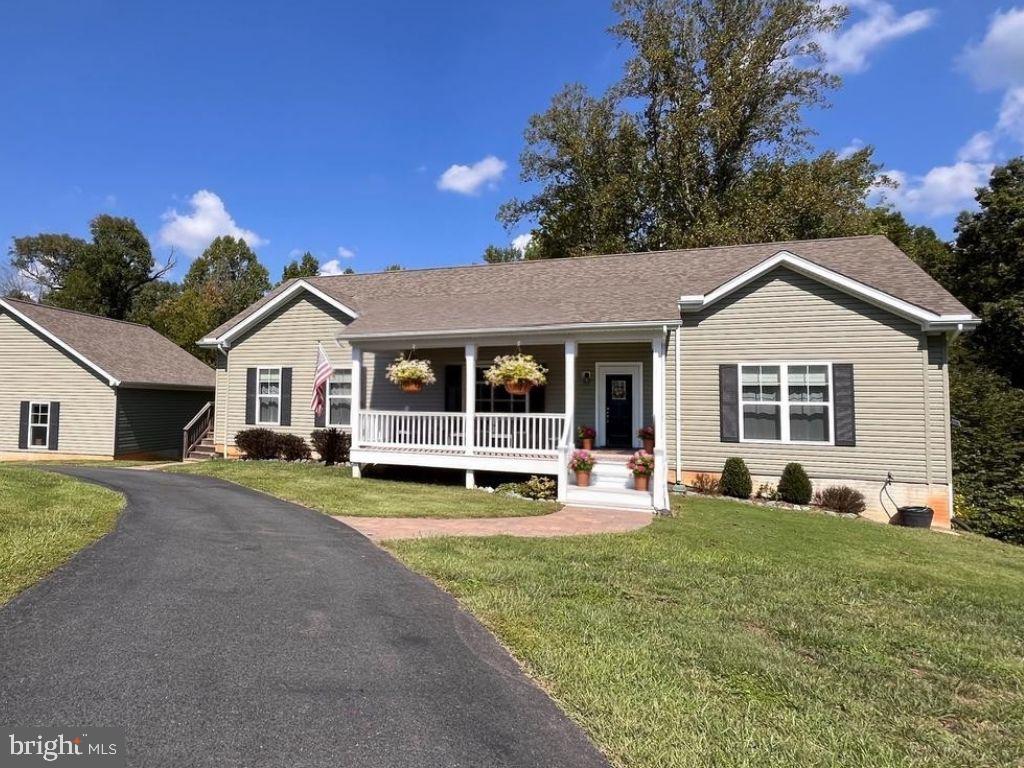 This beautiful 4-bedroom, 3-bathroom home offers a serene retreat with access to Lake Anna's public-side. For all you boating enthusiasts...this home comes with a deeded boat slips at the common area, just around the corner from your house. In the winter, you've got limited seasonal view of Lake Anna out your back window. Relax and enjoy the outdoors with family and friends around the cozy fire pit. There's ample paved parking for guests and vehicles on your circular driveway. The large detached garage is tall enough to install a car lift and is deep enough to store your boat, golf card, and lawn mower. Stream your favorite show or work from home with reliable internet and entertainment services provided by Comcast / Xfinity. The whole-house generator ensures you have uninterrupted power in the case of an outage, adding peace of mind and value to your home. No more running around the house unplugging items during a storm... This house has a whole house surge protector. This home has so much to offer, you'll want to see it in person!