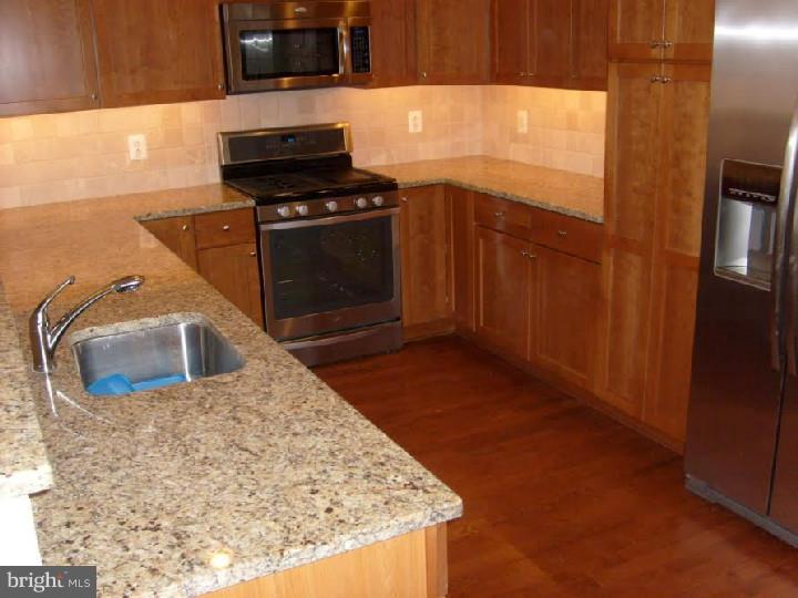 Almost new 2 bed/2 bath Sullivan floor plan with underground parking plus storage... Kitchen has granite counters, breakfast bar, wood cabinetry, gas cooking and stainless steel appliances ....... XL living and dining with recessed lighting, hardwood floors and sliding glass doors.... Split bedroom plan offers extra privacy.... Master bedroom en suite dual vanity bath and walk in closet.... Full size washer/dryer.... Easy living first floor location overlooks grassy knoll.... Naval Square features seasonal pool with sun deck, huge 24/7 fitness center, catering kitchen and meeting room plus historic Biddle Hall rotunda for entertaining or relaxing... Gated security entry with 20 acres of landscaped gardens, trails and pet areas... ALL amenities, water and concierge are included in rent... Rear gate leads to River Park with tennis courts, running and bike trails plus quick expressway access... Shops, services, bus transit and restaurants just outside front gates... Quick walk to Rittenhouse Square or University City....$400 Condo move in/out fee