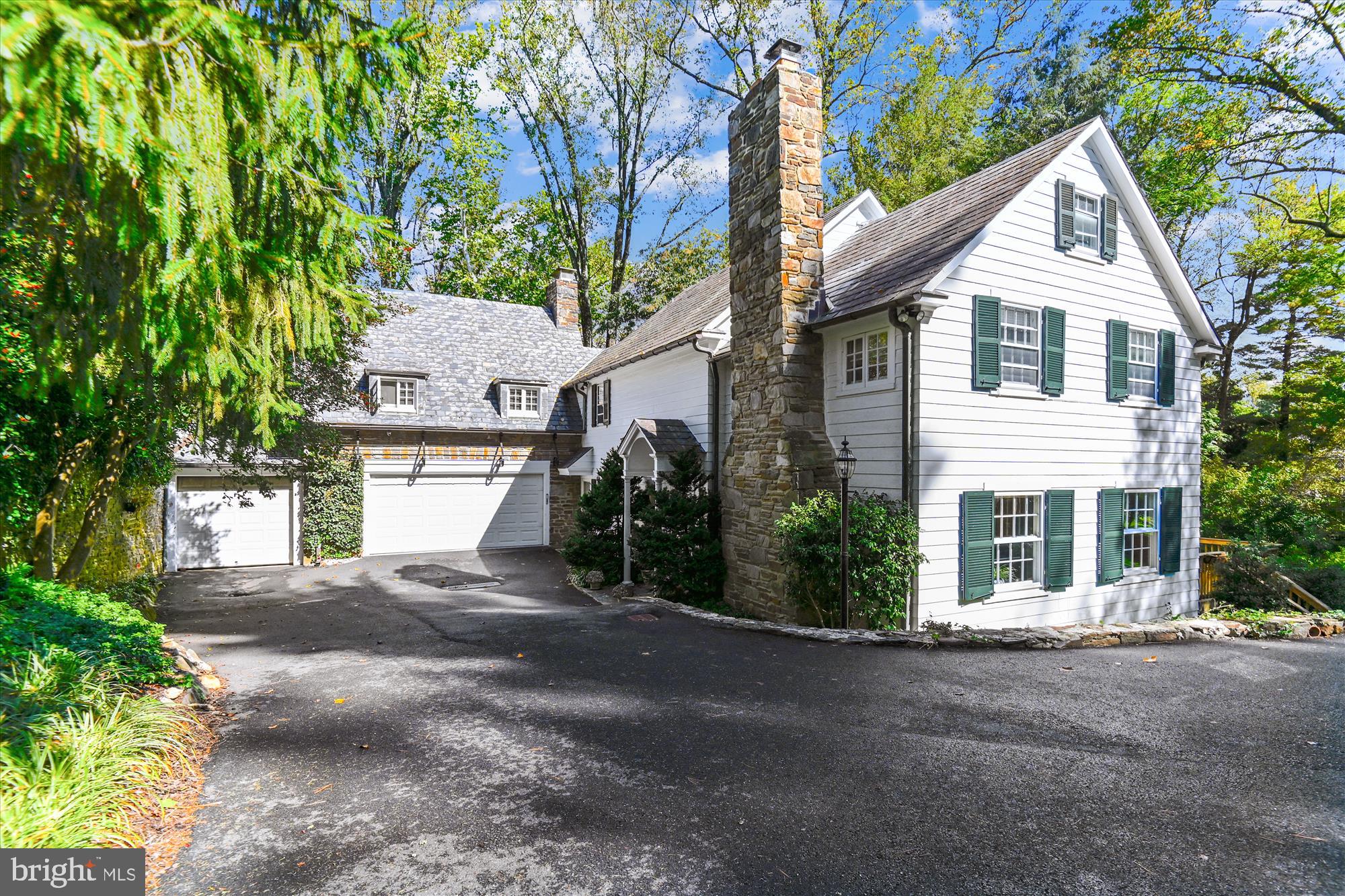 Once in a lifetime! That is how often exceptional homes like this come along for sale. Nestled at the end of Montrose Avenue – everyone’s favorite street in Baltimore – sits this classic home. Two stately stone pillars welcome you into the circular driveway where you witness gorgeous stone walls, a sweeping yard and a blend of stone, slate and wood that make up this home. It’s a visual inspiration. From the moment you cross the threshold, you can feel the stature of this home. Sophisticated and stately meld with comfort and convenience. A large and gracious living room is awash in natural light and flanked on one end by a magnificent fireplace and the other end by French doors opening to the deck. The formal dining room is equally impressive; you can envision the dinner parties that carry over well into the evening. A newly updated kitchen and expanded den is perfect – not too big, not too small – just right. Modern cabinets and counters, radiant heating and windows that overlook the storybook grounds. It’s divine. The second level boasts three wonderfully-sized bedrooms and three full bathrooms. The primary bedroom has lovely nooks and crannies and is the epitome of quiet and calm. The remaining two bedrooms share a bathroom – or can each have their own, depending on your desired configuration. The lower level exudes feelings of warmth and coziness with the perfect walk-out option for sunlight and fresh air. An attached two car garage is a haven for your cars and its proximity to the kitchen makes it feel modern and new. The stone patios and walkways are out of a fairy tale. Endless paths & secret gardens amidst a rolling landscape on over one and half acres. The most amazing stone ‘carriage’ house awaits your finishing touch, but is the perfect place to write the next great novel, host a backgammon tournament or be the envy of everyone who now works from home. Be prepared to be amazed by this exquisite home. It is truly a rare find in one of Baltimore’s most coveted neighborhoods.