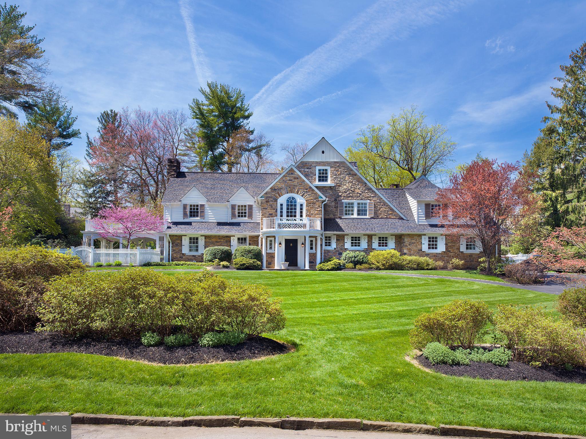 Beautifully sited on one of Bryn Mawr's most desirable streets, this classic Wallace and Warner stone & clapboard estate home was solidly constructed in 1930, has been renovated and expanded by Gardner Fox and is exquisite inside and out. A circular drive lined in Belgian block, stunning mature landscaping, rose/perennial gardens and handsome curved stone walls, welcome you home. This stately Main Line residence offers peace and privacy with 6 bedroom suites (5 on the second floor), 7 full baths and 2 powder rooms. The estate grounds have a recently renovated 20 x 40 swimming pool which is perfectly positioned and not visible from most rooms, flagstone terraces for entertaining, an expansive level area for sporting activities and a covered patio for relaxation. â¨â¨Meticulously maintained, thoughtful infrastructure improvements include a 2015 roof, new basement windows in 2020, third floor windows in 2021, 21 Pella and Marvin windows installed in 2000 (7) and 2015 (14). Azek railings on front & side porches in 2021, refinished wood flooring and new flooring in kitchen and cabana area, exterior painting in 2021-2022 and James Hardie siding in 2021.
Professionally decorated interiors with Farrow & Ball painting, custom interior shutters and Conrad window shades, offer every luxury amenity. Among them is a stunning custom chefâs kitchen with Kountry Kraft cabinetry, full suite of premium quality appliances, large island and radiant heated flooring. An adjacent breakfast room features a gas fireplace and charming window seat. The desirable floor plan perfectly aligns the nearby family room. Brightened by natural light and enhanced with a fireplace and Sherman and Gosweiler custom cabinetry, it can accommodate casual or grand entertaining. Elegant architectural features and decorative moldings are evident in the generously sized living and dining rooms which provide breathtaking views of the grounds. A large cabana area with full bath provides convenient access to the pool area and atrium style greenhouse.
Five en-suite bedrooms (4 with cathedral ceilings) are found on the second floor. The highlight is the primary bedroom suite addition by Gardner Fox featuring windows on 3 exposures, a spa-like bath and sitting/dressing room with custom wardrobe cabinetry. A study offers an ideal space for homework while a separate den is perfect for watching movies. The second floor laundry room and full bath offers convenience.
A bedroom suite with bathroom, large sitting room, walk-in and cedar closets can be also be used as a home office.
This quintessential Main Line home is distinguished by its timeless architecture, modern floor plan, quality construction, and breathtaking grounds which combine to elevate it one of the very highest tier of Main Line properties.