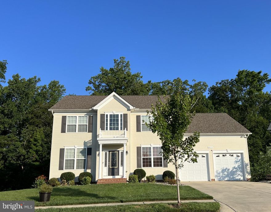 This beautiful colonial has many great features!  Two story foyer, hardwood floors on main level, home office off foyer, separate elegant dining room with crown molding & wainscotting, inviting family room with gas fireplace & mounted TV that conveys, great kitchen w/granite counters, backsplash, stainless steel appliances, gas cooktop, built-in microwave, and island, half bath, laundry room off garage, and large deck off kitchen (great for outdoor entertaining!). Staircase off family room leads to upper level w/ brand new carpeting, four generous bedrooms w/ceiling fans, expanded primary bathroom w/soaking tub, 2 vanities, huge walk-in shower w/bench & private "water closet".  You'll love the finished basement - huge rec room w/luxury vinyl plank floors, recessed lighting, and wired for home theatre, 5th bedroom w/walk-in closet, and full bath - plus sliding doors leading to a lower level deck and patio.  Backs to conservation area - enjoy the wooded view & privacy!  Convenient to shopping & NAS Pax River.  Don't miss out!