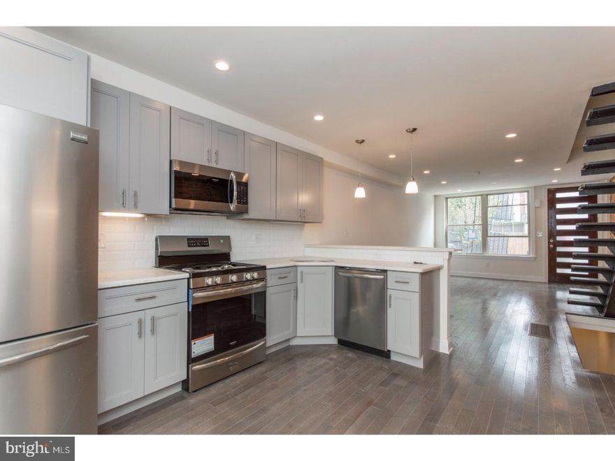 This elegant new construction home is located on a quiet side-street in Point Breeze, one of the city's most sought-after neighborhoods. Enter into the spacious living room, which features beautiful hardwood flooring, a custom free-floating staircase, and exposed brick wall. The main floor has an open layout, which makes for easy entertaining. Continue back into the gourmet kitchen, where you'll find stainless steel Frigidaire Gallery-series appliances, under-cabinet lighting, quartz countertop, and a custom tile backsplash. Sliders off the kitchen lead to a private patio. Upstairs are two bright and sunny bedrooms, both with ample closet space, and an upgraded hall bath with double vanity. Don't forget to check out the roof deck, where there is plenty of space for outdoor entertaining. The lower level is the perfect spot for a home office, family room or even an additional bedroom, as it has a full bathroom in addition to the laundry area. This home is just steps from several great restaurants and bars, and is just a short walk from public transportation and Center City. With all this to offer, what are you waiting for? Schedule your showing of 1316 Bancroft Street today!