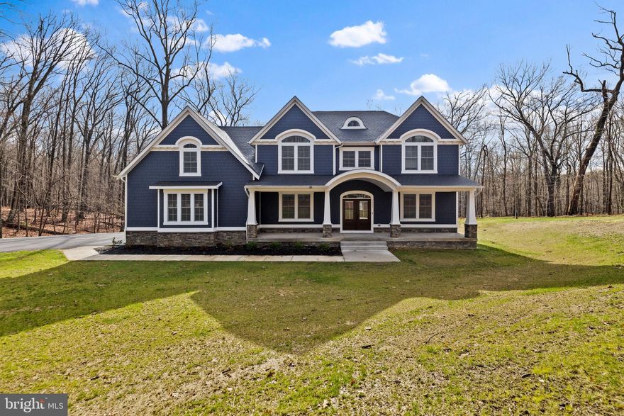 MOVE-IN READY! This stunning custom home by Greenspring Homes offers a luxurious retreat on a sprawling 2.93-acre lot enveloped by peaceful woods. This 6 bedroom, 5 bath home boasts 5,808 square feet of living space, including a 3-car oversized garage. With a striking Hardi Plank front and stone foundation, the home exudes curb appeal and durability. Inside, the main level features an elegant foyer, hardwood floors, a gourmet kitchen with top-of-the-line finishes, a covered screened porch with a wood-burning stone fireplace, and a spacious family room with a coffered ceiling. The upper level is home to the primary suite with a deck, a lavish bath, and a massive walk-in closet, along with four additional bedrooms and a convenient laundry room. The lower level offers a cozy family room with a wet bar, an extra room for a den or exercise area, over 600 square feet of unfinished space that can be converted into a home theater, and a walkout to a new rear patio. This exceptional property combines exquisite design with functional living spaces, making it a truly remarkable place to call home!