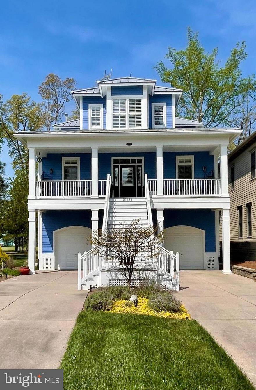 Live graciously in this elegant home, nestled in the prestigious, thoughtfully planned country club community, the Peninsula.  The Miller & Smith Hampton model is situated on the 3rd fairway of the signature Jack Nicklaus golf course in the 'Veranda' section.  Elegant, low country style meets upscale convenience in this well maintained home, perfect for comfortable entertaining and hosting friends and family with discerning style.  Find extensive custom details throughout.  Beautiful millwork, crown molding, chair rail, box paneling, custom built-ins, as well as hardwood flooring and Bahama shutters grace this functional floor plan.  Off the east-facing second story front porch, the wide entry hall is flanked by a formal dining room and a glass doored study.  The first of five bedrooms is just down the main entry hall, complete with custom built-ins and large closet.  Pass the staircase, and the powder room into a large open living area and eat-in kitchen.  The focal point of this ample living space is the natural gas fireplace, framed by large south-facing windows.  Flooded with natural light, this room opens to the screened back porch spanning the width of the home which overlooks the third fairway. Enjoy a glass of wine on this beautiful perch, taking in a sunset moment at the end of your day.  Adjacent to the open living area the gourmet kitchen runs the entire length of the space.  Anchored by the oversized 10' granite island. The space is adorned with tall cabinetry, glass front wine storage, a five-burner gas range, wall ovens, coffee niche and a coordinating butler's pantry equipped with a wet bar - an entertainer's dream. Ascend the side staircase, complete with a custom, cap and bound stair runner onto the open gallery landing above.  To the left, the spacious, western facing primary suite whispers relaxation.  Large enough for a sitting area, and with access to the private third floor porch overlooking the course, you may never wish to leave your room.  Two walk-in closets offer plenty of storage and the upgraded bath features a double sink vanity, jetted soaking tub, walk in shower, separate water closet and make-up vanity, all bathed in natural light from two charming corner windows. Across the landing, past the laundry room is the guest suite that will entice guests to overstay their welcome.  A generous room with east facing windows, a reading nook and ensuite full bath.  The lower level offers functionality with an open mud foyer off the oversized two car garage and a finished storage room. Drop your clubs, beach bag, or pool towels and head inside.  Two more guest rooms complete the lower level, which share a jack-n-jill bathroom and both open to the lower rear porch. Perfect for houseguests to enjoy morning coffee or an evening nightcap. Come experience this sophisticated property.  Live your best country club life at 27434 S Nicklaus Avenue in the Veranda, at the Peninsula.  Note:  Club Membership is mandatory at one of three tiers. Memberships offer access to extensive amenities, and the club and course are considered separate entities from HOA and COA's.  The community offers four pools (one indoor) state of the art fitness center, a full-service spa, private beach, nature center, golf pro shop, billiards room, wine lounge and the award-winning restaurant, The Grille.