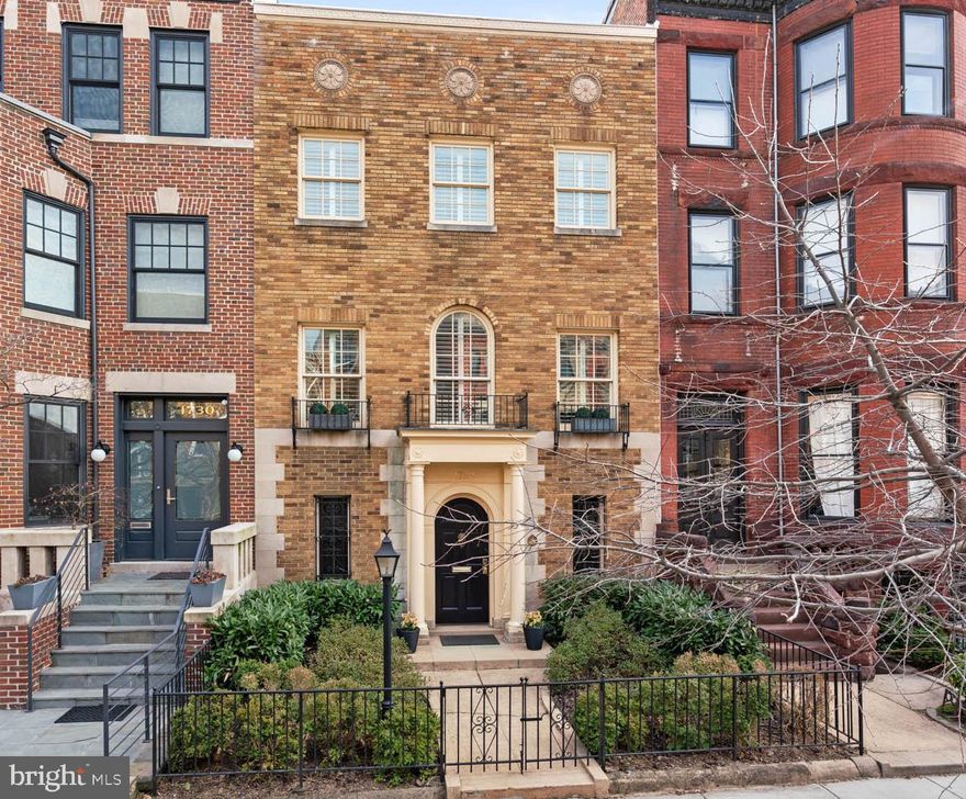 This elegant brick residence was built in 1923 and has undergone extensive updates, while maintaining original details to preserve its historic character. The house features an abundance of natural sunlight from oversized windows, which is further magnified by the high ceilings throughout. A lovely front garden, framed by an iron gate and crafted stone walkway, complements its striking façade. 
Upon entering, the gracious foyer with stone-tiled floors, recessed lighting, and custom millwork sets the tone for the home’s refined interior, highlighted by arched walkways and elegant columns. The floor plan flows seamlessly from the front to the rear of the house, where French doors lead to a tranquil garden and koi pond, creating a serene outdoor retreat. You further access the oversized two car garage from the garden.  
The main level features a gourmet kitchen equipped with stainless-steel appliances, ample cabinetry, and an industrial design that complements the home’s aesthetic. The kitchen adjoins a spacious family room, which opens into a double-height sunroom, further enhancing the sense of space and natural light. 
The second level is dedicated to refined living and entertaining. The formal living room, featuring expansive windows, a fireplace and crown moldings, offers a sophisticated space for relaxation. Adjacent is the expansive dining room, featuring coffered ceilings, a second fireplace, and intricate millwork. An adjoining kitchenette adds functionality, while a discreet staircase provides access to the main level, ensuring privacy and functionality. A large landing between the two rooms leads to a powder room, tucked behind custom cabinetry. 
The third level boasts a handsome primary suite, offering a spacious layout with custom-designed walk-in closets. The en-suite bathroom is complete with dual sinks and a stone-tiled shower and a skylight. There is an additional small room in the suite perfect for a Peloton or an additional closet with a window looking onto the rear garden. Across the hall, the second bedroom suite features a custom two-sided desk, built-in shelving, a fireplace, and en-suite bathroom.
The rear garden offers a private terrace, accessible from both the kitchen and sunroom, nestled among lush gardens and a tranquil koi pond, providing the perfect backdrop for relaxation and entertaining. With its sought-after location, this home offers unparalleled urban convenience, just a short walk from two metro stations, shops, restaurants, parks, and cultural landmarks, offering easy access to everything Dupont Circle and its vibrant surrounding neighborhoods have to offer.
