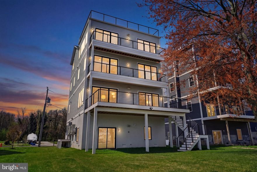 Introducing an extraordinary ultra-luxury waterfront new construction on Miller’s Island, where cutting-edge design meets effortless coastal living. Spanning over 4,000 square feet across four impeccably finished levels, this one-of-a-kind residence offers 4 bedrooms, 3.5 baths, and panoramic views of the Chesapeake Bay from nearly every vantage point.

Built with uncompromising quality and innovation, the home features 600-amp electrical service, dual-zone HVAC with high-efficiency inverter condensers, whole-house humidification, and full spray foam insulation for superior comfort and energy performance. Striking architectural elements include 11-foot ceilings, 9-foot doors, and premium Marvin Windows that flood the home with natural light, all wrapped in durable Hardie Plank siding.

At the heart of the home, a designer chef’s kitchen showcases custom cabinetry, a statement hood, a 36-inch induction cooktop, commercial-grade stainless steel appliances, speed oven, and an oversized quartz island with dramatic full-height quartz walls—perfect for entertaining at scale.  Open floor plan on main level with wet bar and 76” Modern Flames fireplace. Dual sets of 3 panel sliders open to rear tree deck with cable rails for unbelievable views.

Curated for both relaxation and entertainment, the residence includes a private in-home theater experience in the primary suite featuring a projection system with Dolby 5.1 surround sound, along with pre-wired audio throughout. The primary suite is a true retreat, offering a custom accent wall with sconces, retractable projection screen, dual walk-in closets, and a spa-inspired bath with radiant heated floors, frameless glass shower, bidet, and refined designer finishes.

The upper levels continue to impress with spacious secondary bedrooms, a beautifully appointed en-suite, and a convenient laundry room. A top-floor loft with wet bar seamlessly opens to a private deck, creating an ideal indoor-outdoor entertaining space.

The crown jewel: an expansive rooftop deck complete with Duradek and hot tub, delivering breathtaking 360-degree water views—an unrivaled setting for sunset gatherings over the bay.

Additional luxury amenities include EV charging station in 1 car garage, finished lower walk out level, freshly sodded yard, new pier with floating jet ski/kayak dock, integrated security system, whole house generator pre-wired, and smart-home readiness throughout.  

A rare opportunity to own a true waterfront masterpiece where modern luxury, technology, and coastal elegance converge.