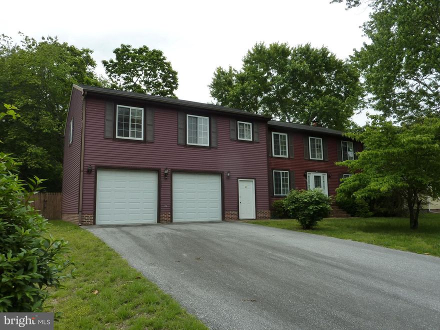 One-of-a-kind Colonial has 3 bedrooms with 2.5 baths in the main house, and a self-contained 2 bedroom, 1 bath in-law suite above the oversized 2-car garage. Paved driveway, wooden privacy fence around the large backyard, brick walk to front door, formal dining room, U-shaped kitchen with breakfast bar plus 2nd dining area, large wood-burning brick fireplace in the living room, and a mud room/laundry room with half-bath just off the garage. The 2-car garage is 26x16, with two automatic door openers, shelves and cabinets, a utility sink, and has entrances to the front yard, main house, backyard, and in-law suite. The in-law suite provides a completely independent living space: open living/dining/kitchen great room, 2 bedrooms, a full bathroom with tub/shower and a double closet for linens and storage, plus a laundry/storage closet with a stack washer/dryer and built-in shelves. The suite can be accessed (or locked off!) from the garage and the main house. Natural gas heat, 2-zone heating and cooling, and city water/sewer/trash. Owners have a home warranty that can transfer to buyer.