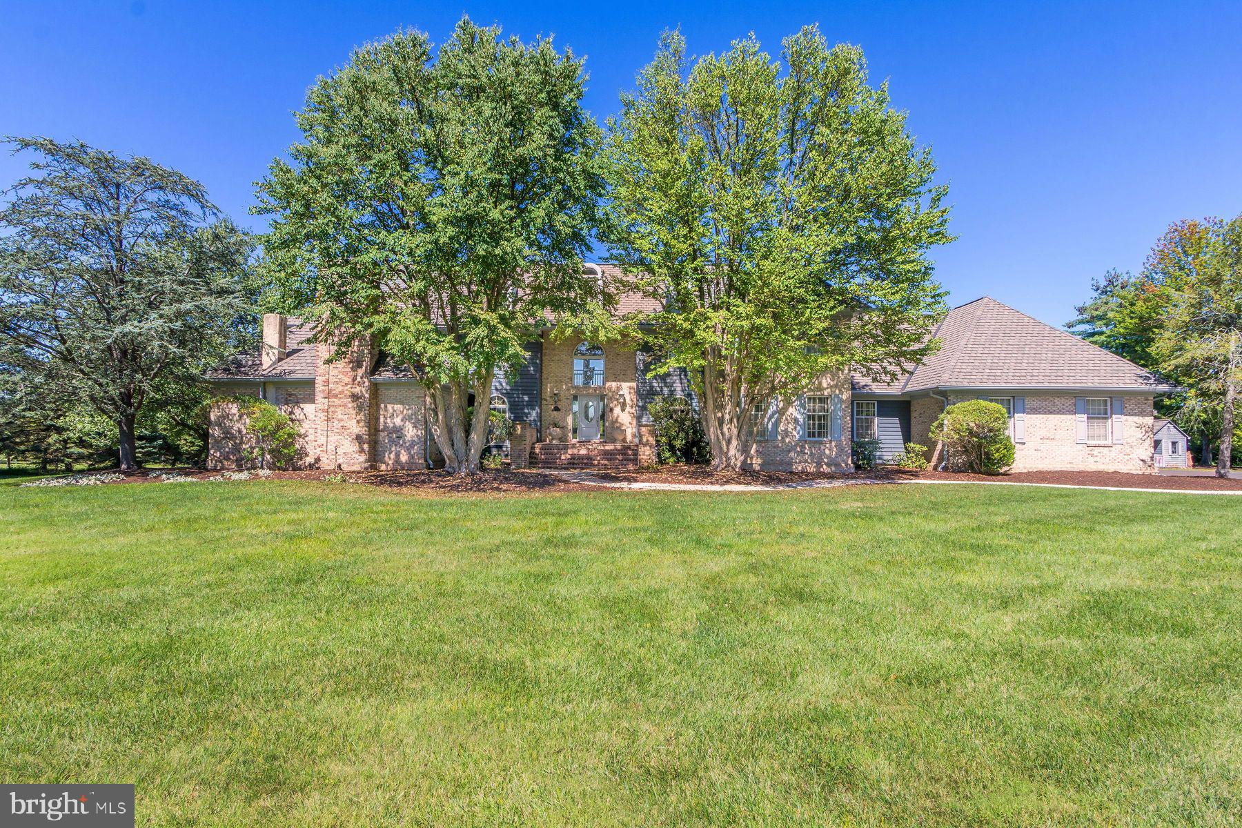 Nestled on over 5 acres in desirable Upper Makefield, Bucks County, this property offers a private setting with a long drive leading back to serene grounds, mature landscaping and long distance views of the beautiful countryside. The home includes many sought after amenities including a large first floor primary suite with sitting area, fireplace, en-suite bath with jacuzzi tub and double walk in closets There is a dramatic two-story great room with a floor to ceiling stone fireplace, large windows, doors leading out to the terrace and deck area and a full size wet bar making this a perfect spot for both indoor and outdoor family gatherings or entertaining. There is also a huge bright 2 story kitchen with a large center island and lots of cabinet and counter space and a lovely glass atrium breakfast room overlooking the gardens and grounds. Also on the main floor is a formal dining room, living room, library/ office and laundry room. The home offers a large year-round indoor pool area complete with tile floors, open stone wall, a stone shower area and a sauna. There is also deck area surrounding the pool with walls of windows perfect for enjoying all four seasons while relaxing by your own private pool. The second floor has an additional 3 well sized bedrooms with walk in closets and 2 baths. The grounds are very private and include a terrace and multi-level decking with beautiful gardens and magnificent views of the countryside. The property is conveniently located just minutes from Newtown with a huge variety of shopping, dining and area schools. It is 10 minutes to I-95 and an Amtrak train station, 70 minutes to NYC, 45 minutes to Philadelphia and 30 minutes to Princeton.