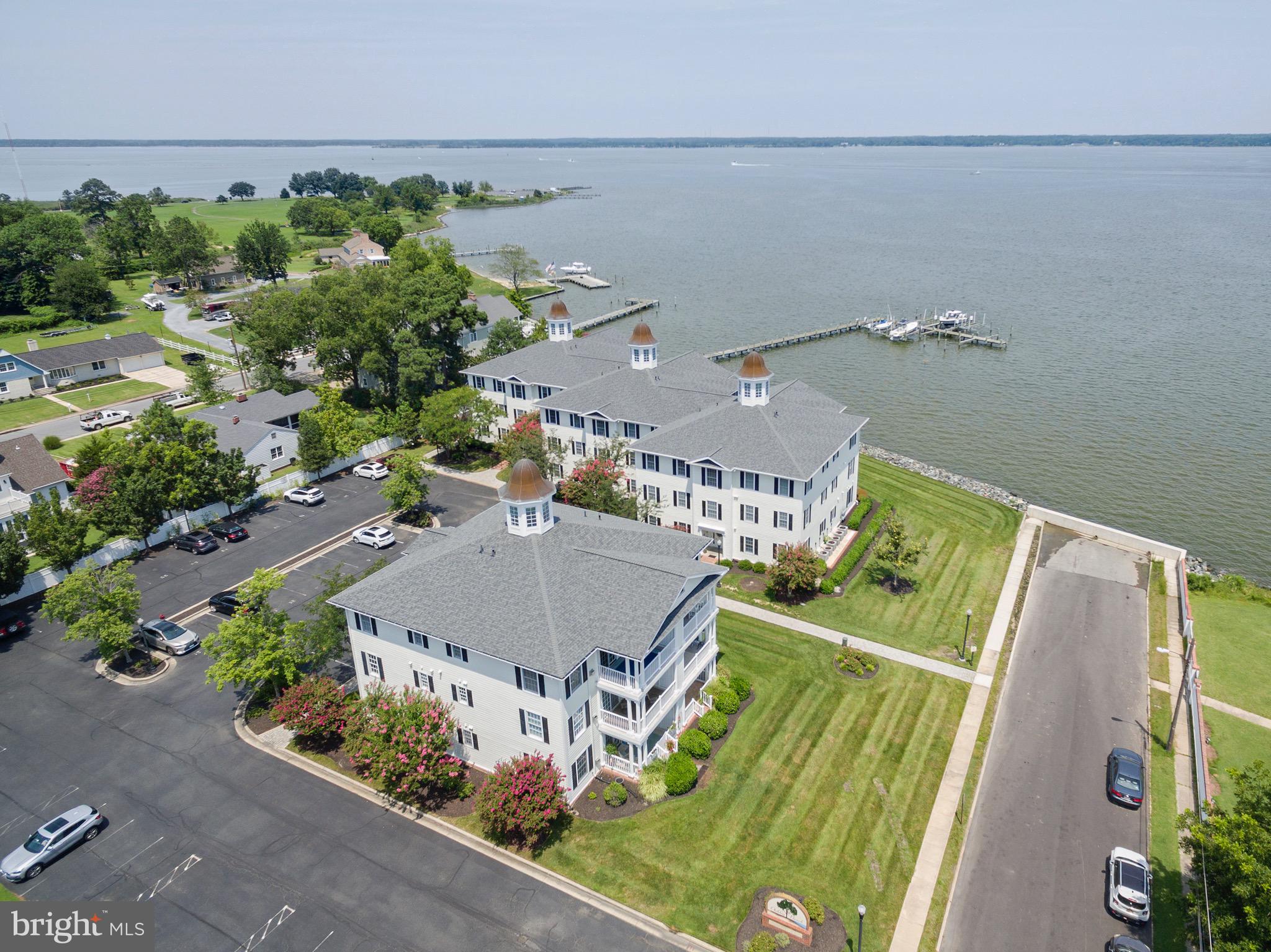 Enjoy Oakley Beach Condominiums with broad views of the Choptank River, off a quiet street in Historic Cambridge. The condos were built on the grounds of the previous Oakley Beach Hotel. The complex is small with four buildings, each housing six units, a private community pool and pier with slips. The buildings are staggered for added privacy for each units waterside balcony/porch.
Building 5, Unit 102, has 2 bedrooms and 2 baths. Riverside 'open concept' living with Kitchen, Dining and Living area. Gas fireplace and covered waterside porch add to your comfort in this condo. There is private off street parking. Boat slips are available.
Square footage to be verified by buyer.