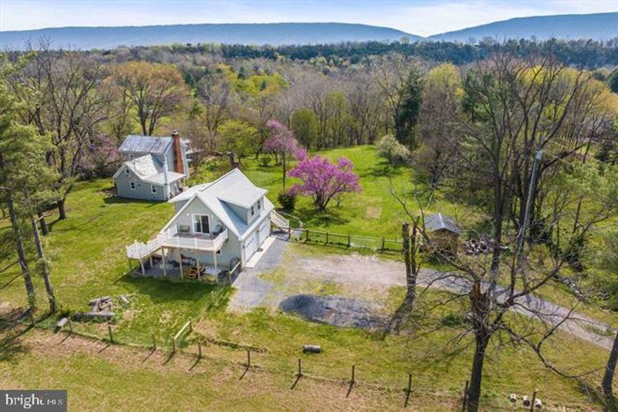 RIVER FRONT 2 Houses AND a 30x26Garage with Full Apartment! Historic Pre Civil War River Front Farmhouse estate situated on the banks of the famed Shenandoah River - The Jacob Swartz House a 1852 built pre-Civil War gem on 3.4+ acres with over 400 feet of PRIVATE Shenandoah River frontage. The Jacob Swartz House features 3 charming dwellings. **Main Farmhouse:** A beautifully updated space with a cozy living room, bedroom, and bathroom on the main level plus a spacious primary suite upstairs and an additional bedroom area, totaling 1,348 sq. ft. **Cobbler's Cottage:** This 2-bedroom, 2-bath cottage is perfect for guests, featuring a screened porch, full kitchen,& living room & 2 bedrooms & 2 bathrooms overlooking the river. *Garage with Living Space:* A detached 2-car garage offers finished living space above, including a kitchenette and bathroom—ideal for visitors/airbnb etc. Enjoy breathtaking river views and tranquility. Tremendous potential for a BnB, Multiple Airbnbs, a family compound or in-law quarters. You could reside in one home & rent the others to cover your payment. The grounds are beautifully landscaped w/perennials & evergreens. Minutes from Bryce, Civil War Battlefields, Luray & Shenandoah! A river front oasis!