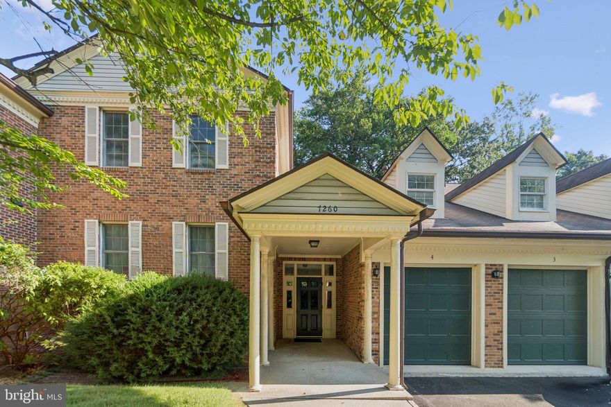 Highly sought-after Glen Hollow condominium with attached garage and extended driveway. This top-floor unit offers a spacious balcony with private wooded views. Recent renovations (2025) include an updated kitchen and bathroom. The kitchen features quartz countertops, quartz backsplash, and new stainless steel appliances—refrigerator, dishwasher, and microwave. Additional highlights include laminate flooring throughout, a gas fireplace in the open living room, and a full-size stackable washer and dryer. Conveniently located within walking distance to shopping and dining, with easy access to I-495, I-395, and public transportation.