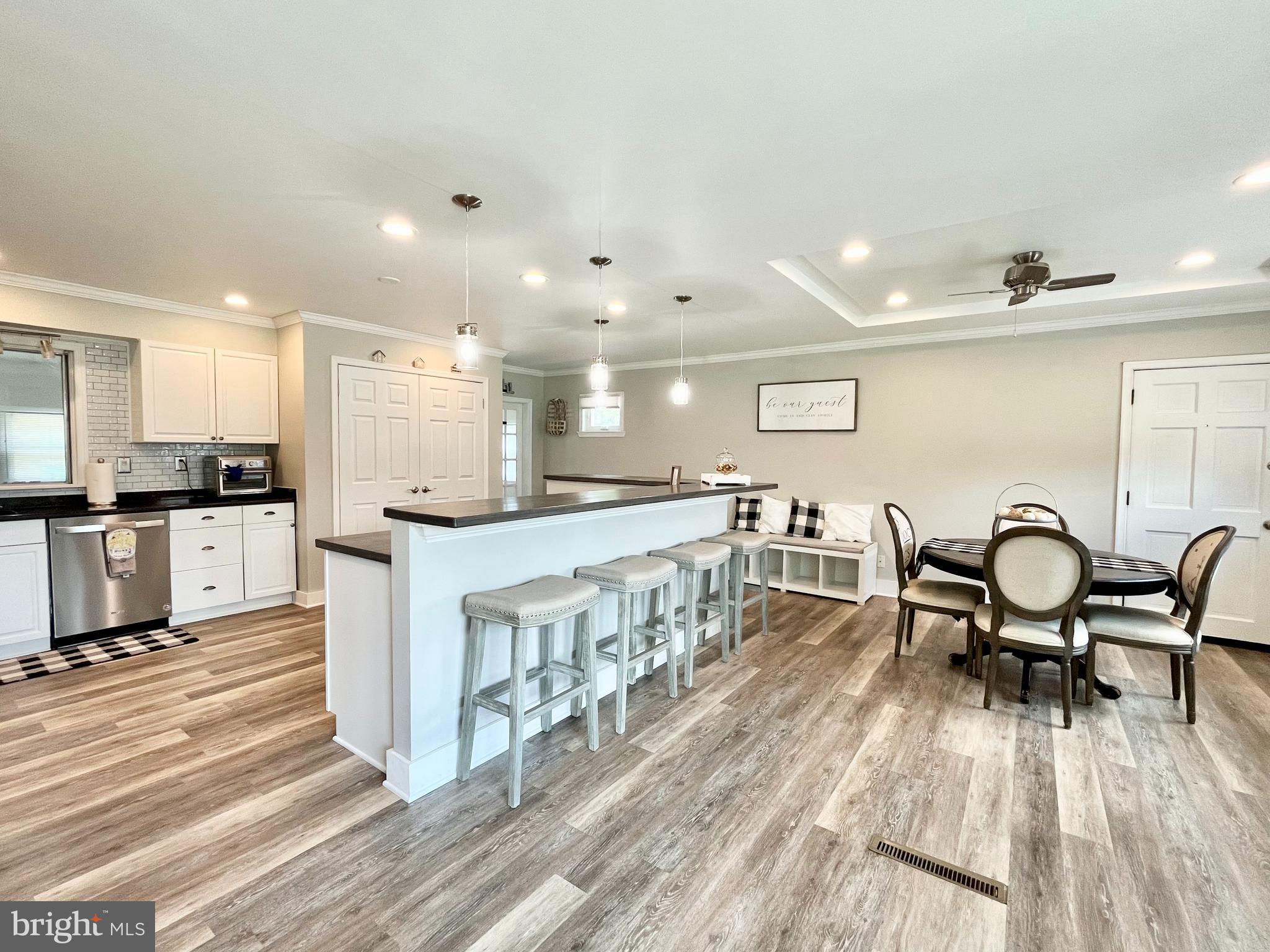 Step into this home and realize that this is the one you've been waiting for.  The owners of this home took great pride in it and turned a simple ranch home into the custom home of their (and your) dreams!  The new custom floor plan allows for a super spacious custom kitchen that is the heart of this home.  With its new stainless steel appliances, huge pantry and oversized island with custom maple countertops, this is where your family will gather to share your days.  The open floor plan allows this space to continue into a dining area with tray ceiling and comfortable living area all grounded by new luxury vinyl tile flooring - perfect for the busy family! Need more living space?  A family room has been added to the rear of the home which creates a second living space and is large enough to accommodate an office, play area, or game space.  Situated quietly down the hall sit three good sized bedrooms and updated hall bath.  If that's not enough, the owners have added all new windows, new flooring throughout, custom baseboard molding,  new insulation, new high hat lighting, new HVAC system with smart thermostat and new mini split to heat and cool the family room.  Want even more?  Step out the rear door to a newly installed concrete patio and large fenced rear yard.  New landscaping completes this gorgeous and move in ready home.  Situated in a quiet neighborhood yet close to shopping, restaurants, and public transportation.  Don't wait on this one!  Make it yours today!    All offers due by Tuesday 6/28 by noon.