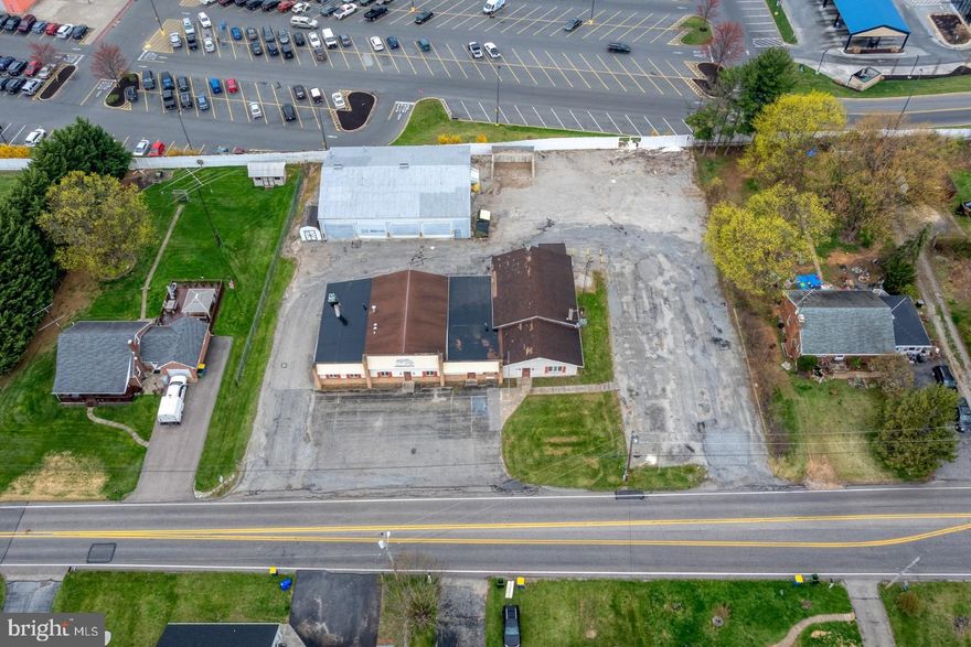 **THIS IS AN ONSITE ONLY LIVE IN-PERSON AUCTION. Property Highlights: .97 Acre with 2 Structures Providing 10,000 Sq. Ft. of Office and Utility Area - Large Parking Lot with Ample Room to Turn Around Semi Trucks - 50’x70’ Heated Garage Building Offers (5) 14ft Garage Doors, Small office and Bathroom - Main Block Building Features 5 Bathrooms and Lots of Office Space - Main Building is Wheelchair Accessible - Shop Heated by Gas Fired Modine Heaters and Office Area Heated by Gas Forced Air Furnaces and Electric Baseboard. Central AC in Main Building - Prime Area with High Traffic Count, and Close Proximity to Other Businesses and Attractions - Public Water and Sewer - Total Taxes: Unknown. Whether you're starting a new business or expanding your existing business, this property provides everything you need for success. Properties like these are rare. Don’t miss out on this incredible opportunity!