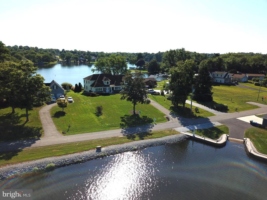 Welcome to Your Paradise on Lake Meade -- -

Experience elegance, grace, and tranquility in this stunning 4,200-square-foot waterfront retreat, thoughtfully designed for both formal and casual lakeside living. Built in 2014, this two-story residence showcases an open-concept layout, seamlessly blending comfort with sophistication.

Walls of glass throughout the home invite natural light to dance across the interiors, capturing breathtaking views of the lake (from both front and back) and creating a vibrant, airy ambiance. At the heart of the home is a chef-inspired kitchen, featuring a distinctive arched island and adjacent to the dining room — perfect for hosting everything from elegant dinner parties to intimate family meals.

The expansive owner’s suite is a private sanctuary, occupying its own wing and offering panoramic views through a magnificent glass wall. It is a space of quiet luxury, designed for both relaxation and retreat.
In addition to the primary suite, the home offers two spacious en suite bedrooms, along with a versatile fourth bedroom or bonus room—ideal for guests, an office, or a recreational space.

Step outside to impeccably landscaped oversize lot that naturally guides the eye to the shimmering lake and your private, architecturally designed boathouse with deck—a must for entertaining or quiet evenings by the water.

This exceptional home delivers the best of lakeside living, where luxury meets nature in perfect harmony. Come home to Lake Meade.