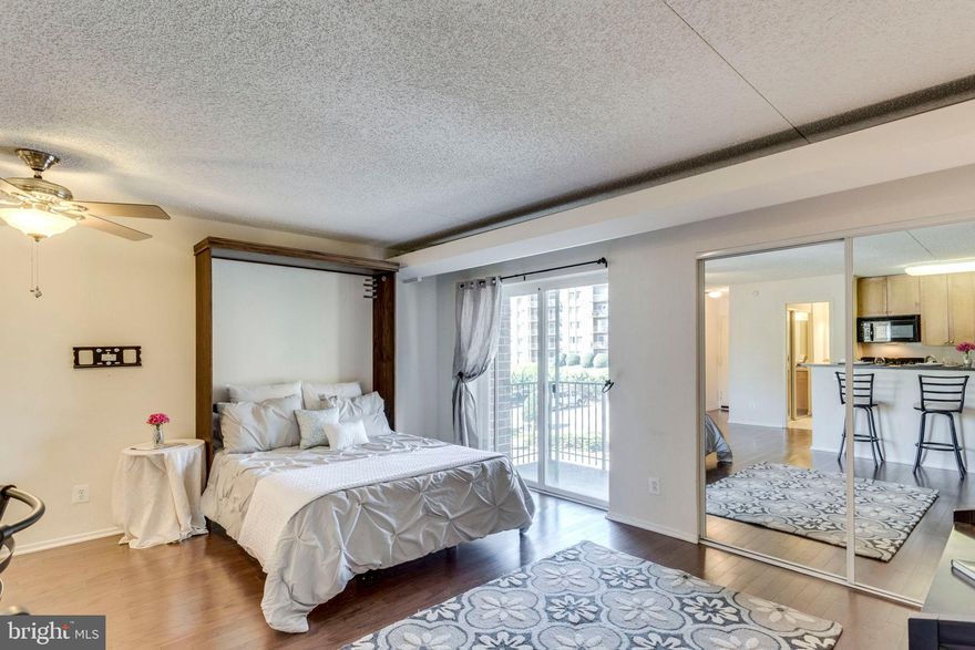 Perfect commuting location! Spacious, perfectly apportioned studio with hardwoods and full bath.  Full galley kitchen with lots of counter & cabinet storage plus eat-at bar.  Making your bed will never be so easy again with the murphy bed that conveys! 2 huge mirrored closets for storage.  Full, spacious bath with large vanity and tub/shower.  Laundry room in same building.  Condo fee includes ALL utilities plus 1 assigned parking + one visitor parking pass. Tons of community amenities: clubhouse, fitness center, pool with adjoining BBQ & party area, tennis and volleyball courts, dog park and more! Free shuttle to Van Dorn Metro, bus stop steps away from your front door.  Major commuting routes, Old Town, Arlington, Reagan National and Washington DC only a short drive away!