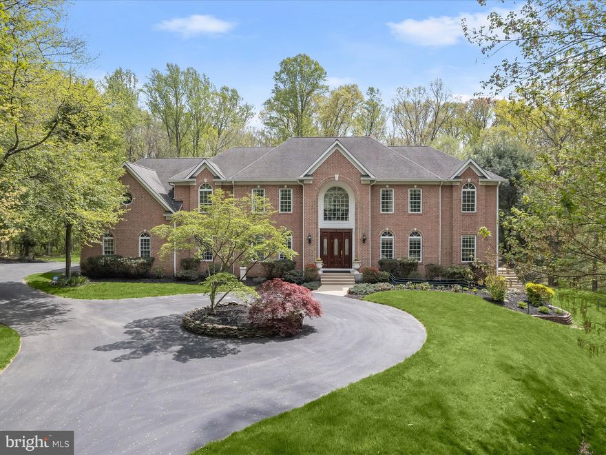 Welcome home to 8516 Edenton Court, one of the finest residences in Fulton, Maryland. This magnificent estate home is situated on nearly two secluded acres within the exclusive Beaufort Park enclave. Boasting more than 10,600 square feet of luxury living space, the seven bedroom property also features an eight-car garage, stunning in-ground pool with hot tub, theater room, in-law quarters, sunroom, multiple laundry rooms, custom trim work throughout, and so much more. You’ll enjoy serene space and privacy surrounded by a breathtaking wooded backdrop flanking the Rocky Gorge Reservoir, yet you’re still just minutes from the convenience of Maple Lawn’s bustling shops and restaurants. 

The grand two-story foyer with a large Palladian window sets the tone for elegance and sophistication. The main level features a formal living room and dining room, both adorned with trey ceilings, crown molding, chair rails, and elegant lighting. The kitchen is a chef’s dream equipped with custom cabinetry, a Wolfe 6-burner range with griddle and double oven, and a Sub-Zero refrigerator complemented by a prep sink and beverage refrigerator on the island. A spacious eat-in area opens to the upper level terrace via French doors, while a sunroom with custom windows offers stunning views of the outdoor oasis and pool. Additional amenities include two half-bathrooms and a main level laundry room/mud room. The heart of the home is the two-story living room with a gas fireplace and French doors leading out to the terrace, adjacent to the custom theater room and a spacious office.

This exquisite upper-level features a dramatic catwalk-style landing leading to a luxurious primary bedroom adorned with hardwood floors, a spacious sitting area, and an expansive walk-in closet. The primary bathroom is a spa-like retreat with a jetted tub, dual sink vanity, and elegant marble tile flooring. Two secondary bedrooms share a buddy bathroom, while the other two are served by a conveniently located hallway bathroom. The laundry room is also found upstairs. The sprawling lower level offers an additional full kitchen, a charming dining area, and a living room with multiple doors opening to the picturesque patio. The game room area offers endless fun, while a guest bedroom and a full bathroom nearby provide comfort for visitors. A luxurious guest suite with an en suite bathroom offers direct access to the pool and pool bathroom, enhancing the indoor-outdoor experience. Completing the lower level is a utility room and convenient access to the garage. A premiere offering like this doesn’t become available often and its grandeur is only fully appreciated in person. Schedule your showing today.