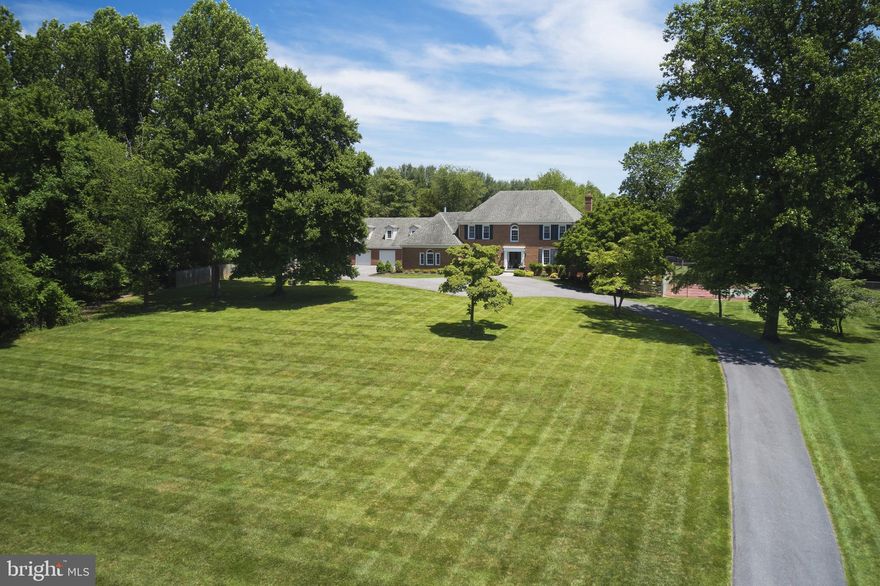 You are invited to tour this magnificent country estate with the perfect blend of superb design and family comfort! Main home gives you 5 bedrooms 4 1/2 baths with 5,886 sq. ft. of living space..Plus there is a beautiful fully equipped 1 bedroom 1 bath apartment above the 3 car garage (in addition to the attached 2 car garage)  with an additional 744 sq. of living space ideal for your guests...for a combined total of 6,630 of fabulous living space! The open floor plan and windows allows plenty of natural light giving you wonderful views of the beautiful in ground pool, fenced in lighted tennis court and landscaping.  Perfect for family fun and entertainment yet this home feels cozy and warm.  Pictures are worth a 1000 words so view all these beautiful photos, see what a fabulous opportunity you have to make this your home!
Main Level - Spacious entry level with double closets, LVP onn entire level, crown moulding,recessed lights throughout, large separate formal dining room, laundry / mud room with sliding barn door and access to garage, gorgeous conservatory / music room with floor to ceiling windows, grand family room off kitchen with gas fireplace, large informal dining area with french doors leading to beautiful sunroom with views o pool, deck, and patio, tremendous gourmet kitchen ideal for entertaining, quartz countertops, lots of 
cabinet space, Bosch dishwasher, SubZero refrigerator, induction stove top, double door wall oven, huge double size pantry, large island with room for 4 plus stools, built in microwave,built in wine/beverage cooler. Upper Level -  entire level is carpet, 3 excellent size bedrooms with one having a full bath, additional hall full bath, Spacious primary bedroom suite, 2 walk in closets plus 1 additional closet, glass doors lead to private office / nursery with wood burning fireplace, 2 large sky lights, large L shaped closet with shelving,  incredible master bath, marble floor, oversized shower, free standing soaking claw tub, two separate vanities, large sky light.  Lower Level - walkout, huge entertainment area with hard wood floors, wet bar & fridge, recessed lights, full updated bath, Jr. master suite  with LVP floor and lots of space for a home gym, Additional room for storage with utility tub.
2 car attached garage, 3 car detached garage with a upper level 1 bedroom apartment, air conditioned, heated, one full bath, full kitchen and living area!
HARDWOOD FLOORS ARE UNDER UPPER LEVEL CARPET