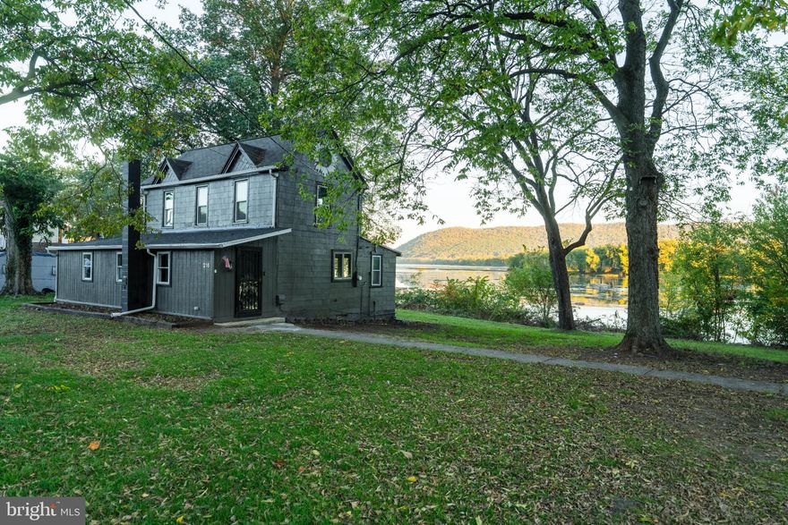 Located along the Susquehanna River in Perry County, this fully renovated farmhouse-style home offers a peaceful riverside setting and modern comfort. With 1,600 square feet of finished living space, the 1930-built home was updated in 2025 to blend historic craftsmanship with practical upgrades. The property spans 0.73± acres and provides approximately 200± feet of private river frontage, making it an appealing option for those who value access to water recreation and scenic views.

Inside, the home features hardwood and luxury vinyl plank flooring throughout. The main living area centers around a wood-burning fireplace that provides both charm and function, while the electric baseboard heat and 200-amp service support modern living. The kitchen includes an electric oven and range, offering convenience for daily cooking. The home’s two bedrooms and single full bath are situated across two levels, with a thoughtful layout that maintains privacy while optimizing available space. The absence of a basement simplifies upkeep, and a crawl space foundation supports easy maintenance access.

Outside, a detached garage and carport provide ample parking and storage for vehicles, boats, or outdoor equipment. The lot’s combination of open lawn and riverbank frontage makes it well-suited for outdoor activities such as kayaking, fishing or simply relaxing by the water. The property’s location along Railroad Street allows for both paved and gravel road access. While the home provides a private setting, it remains close to local amenities, including dining, shops and schools within Duncannon and surrounding communities.

The Susquehanna River forms the eastern boundary of the property, offering navigable water and riparian rights. Whether used as a primary residence, a recreational retreat, or an investment property, this home’s river access and recent renovations make it a distinctive opportunity within Perry County. The home is within the Susquenita School District and zoned R1 under Penn Township.

Buyers should note that the property lies within an AE flood zone, defined as an area with a 1% annual chance of flooding and a 26% chance over a 30-year period. Flood insurance may be required by certain lenders. Utilities include well water, on-site septic and electric service. Internet and cable are available in the area, providing year-round connectivity for remote work or streaming.

With a combination of practical updates, accessible riverfront, and a manageable lot size, this property delivers an attractive balance of comfort and outdoor lifestyle. Whether envisioned as a full-time residence or a getaway near the Susquehanna, it offers lasting appeal in a scenic part of Perry County.