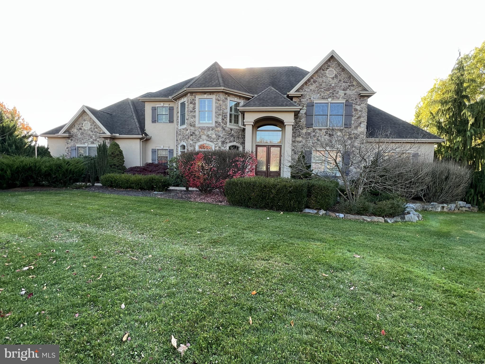Stone and stucco home in WENTWORTH ESTATES with 1.05 AC lot features 6/7 bedrooms and 5 full and 2 half baths. The MAIN LEVEL primary suite has a sitting room, tray ceiling, a TWO person jacuzzi soaking tub, walk in tile shower and dressing area with TWO large WALK IN closets, and custom window treatments. The 2nd floor boasts a large bedroom suite with a tray ceiling and custom window treatments and has a large bathroom with a jacuzzi soaking tub, walk in tile shower, and a large closet. Two bedrooms with walk in closets share a Jack and Jill bathroom. Two bedrooms with walk in closets share a bathroom. The living space is 6500 sf for the first and second floor and a 2330 sf lower level with a full bathroom and optional bedroom 7, plus an additional separate POOL BATH with access off of the pool. This home has an open floor plan with a living room and great room attached to the gourmet kitchen that features a 60" WOLF French top gas range with an additional WOLF wall oven, a microwave and warming drawer, and SUBZERO built in Refrigerator and Freezer. The kitchen has TWO ISLANDS with sinks and dishwashers and TWO beverage centers that make this kitchen a great place for family gatherings and entertaining. The large pantry will house all of the kitchen essentials and the breakfast room is a great place to gather. The great room features a full wall of stone that has a wood burning fireplace that makes the space feel cozy. The living room has a two sided gas fireplace that sees through to an attached deck that overlooks the private back yard pool and built in grill entertaining area. EXPOSED FINISHED WALKOUT LOWER LEVEL opens to a large covered patio, courtyard and pool. The lower level has an exercise room, wine cellar, and full custom wet bar with a THIRD dishwasher. The entire rear yard is fenced for privacy with TWO levels. The lower level has the pool area, the upper level contains second entertaining area with flag stone patio and a FIREPIT. TWO offices -first floor and lower level. TWO laundry rooms - first floor and 2nd floor. The home has an attached 3 car garage and an additional 2 parking spaces. Mudroom with built-ins. Built in window candlesticks, central vac, home/fire alarm system. Beautiful mountain views. Cumberland Valley School District. Owner is a licensed broker in the state of PA.