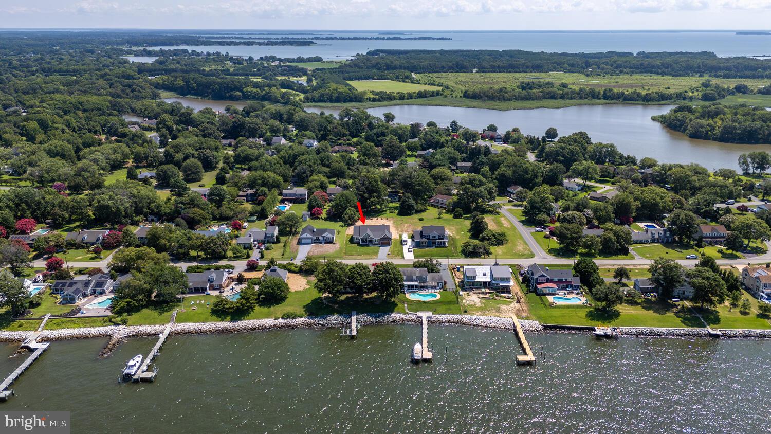 Schedule your showing now! Going active 7/24/2025. Welcome to this brand new home in the sought after waterfront community of Queen Anne Colony. This 4 bedroom, 3 1/2 bath home is awaiting for you! Queen Anne Colony is situated between the Chesapeake Bay and Price Creek. This home has water views from the spacious front porch and the 3 front bedrooms. This community has a park which consists of a pavilion, playground, picnic tables, basketball court and an open field for homeowners. It also has access to the Chesapeake Bay Overlook, so you can watch sunsets or the fireworks on Independence Day. There is a kayak launch for kayaks and canoes with easy access to Price Creek. There is something so special and peaceful in an established community that you can't just "create" in a new development. Adjacent to many other businesses. A few are the Queen Anne Marina which is a full service marina with boat slips, fuel, utilities, storage, etc. and The Silver Swan Bayside. Also, the Blue Heron Golf Course and the South Island Trail (a 7-mile paved trail that ends at the Romancoke Fishing Pier) too. These businesses and amenities are within 5 minutes of this new home. Now that you have found your dream neighborhood, welcome to your dream home. Upgrades galore both inside and outside. Starting from the outside with the pillars, siding, stone, garage door, exterior double front door, and landscaping. Including the gorgeous, statement piece with the cedar ceiling on the front porch. Venturing inside, the family room and kitchen are dreamy. Tons of natural light from the back wall lined with windows. A custom fireplace upgraded with tile and flanked by cabinetry, topped with quartz (which matches the kitchen). Also includes, floating shelves and lighting. It has a show stopping step tray ceiling. The family room is completely open to the kitchen. If you are looking for space, storage and room to spread out in your kitchen, look no further. A 12 foot island with plenty of room for extra seating. Along with the back row of cabinets measuring around 20 feet long! Energy Star appliances which are all stainless steel. Includes a French door Smart refrigerator, Smart built-in microwave, dishwasher, Smart double wall oven and a 5 burner recessed gas cooktop. For added convenience, this home also includes a butlers pantry, which is where your microwave and wine/beverage refrigerator is located. The quartz continues in the butlers pantry, so there is space for you to do prep work too. Off of the kitchen is an eating area, which leads to an outside porch, ready for peaceful evenings or lively crab feasts, whatever your heart desires. Your 2 car garage is around 535 sqft with extra room for storage (bikes, etc.). It leads directly into the mudroom/laundry room. The laundry area includes more cabinetry(more floating shelves) with a sink and quartz countertops. It also includes a custom built-in for your shoes, jackets, umbrellas, etc. In this "area" of the home, is an entire room with more custom built-ins. Whatever you need to store, this is your room! 3 of the bedrooms are located in the front of the house, one could easily be an office. Each room has water views of the Chesapeake Bay. 1 room has an attached full bath and the other 2 share a full bath. 2 of the front bedrooms have walk-in closets with upgraded closet systems. Lastly, the primary bedroom and bathroom are located in the rear of the home, which provides privacy from the other 3. The primary bedroom includes 2 separate large walk-in closets. One of the closets has custom built-ins for all your needs. The en suite bathroom includes 2 separate vanities, a tiled shower and free standing soaking tub. It is spacious with a little bit of glam. This home has the coastal KI vibe you are looking for! More upgrades include LVP flooring seamlessly throughout, trim, windows and the conditioned crawlspace with drain tile and sump pump. Schedule your showing today, so you won't miss it! MHBR:7172