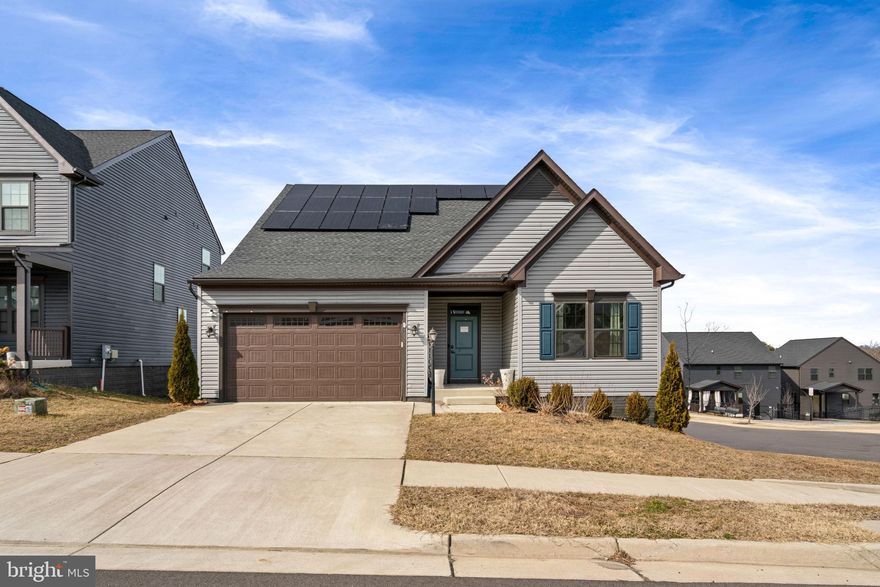Less than five minutes from the heart of Downtown Fredericksburg, Check out 1601 Rampart Drive!  This charming raised ranch home, Constructed in 2021, has four bedrooms and 3 full baths. The Bremante Ranch offers Main level living with a basement and combines modern comfort with inviting warmth. A Corner lot in the Fredericksburg Park community with easy access to Downtown, The Virginia Central Railway trail, Alum Spring Park, the VRE, and I-95. Minutes from Central Park and Mary Washington College. Out front you will find a concrete driveway, with attached 2 car garage, and covered front entrance. Step inside to the foyer and you'll find two carpeted bedrooms, with a full bath complete with a tub/shower combo. Continue into the main living area, with LVP floors throughout. To the left you'll have a mudroom with access to the garage and stairs to the basement. Next you come to the Open concept Kitchen, living and dining area. Flooded with natural light. Enjoy your morning coffee or entertain guests on the covered composite deck right off the dining area. The kitchen includes a spacious island with room for four seats, white quartz counter tops, and stainless steel appliances. There is a built-in wall oven below the microwave, a gas cook top/stove, and a pantry. The Kitchen opens up into the living area complete with a gas fireplace perfect for cozy evenings. Off to the right you'll find the laundry room, and the carpeted Primary bedroom, with windows overlooking the backyard, en suite bathroom and walk in closet. The primary bath includes a double sink vanity and walk in shower. Heading to the basement, you have a huge recreation area with LVP flooring, a carpeted large bedroom, and a full bathroom with a walk in shower. Just off the recreation area you'll find an ample unfinished storage space with the utility area. The basement has walk-out access to the fenced in back yard with a stamped concrete patio. Solar Panels will be paid off at closing.