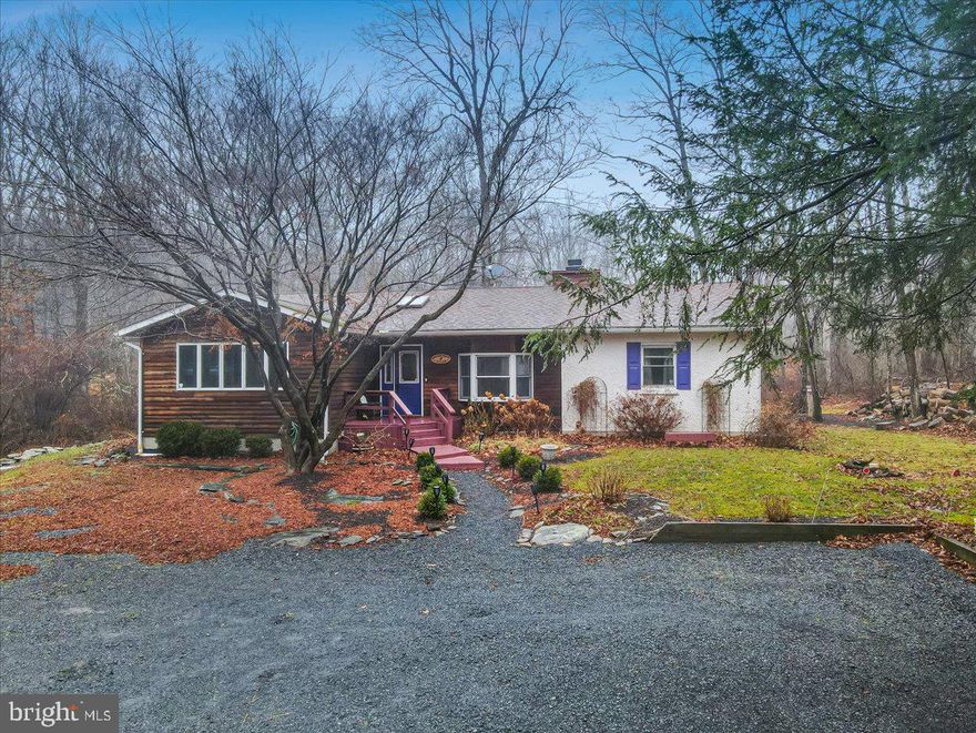 If you are looking for a SERENE ZEN-LIKE COTTAGE setting, NESTLED STREAM SIDE on a 1.70 ACRE LOT for your primary or vacation home with lots of UNIQUE CUSTOM and whimsey features then this charmer is for you! Enjoy 2000 sqft of ONE LEVEL LIVING with 3 BEDROOMS and 2 Full BATHS and CENTRAL A/C! With Beautiful HARDWOOD FLOORS and NATURAL LIGHT flowing throughout, you will instantly feel warmth and inner peace at first sight! A nicely appointed kitchen offering a stainless steel gas stove, built-in BREAKFAST NOOK, GRANITE counters & WINE/COFFEE BAR serves as an aperitif before stepping onto the custom stream side deck ready for your dining pleasure or just your morning coffee chat with an abundance of nature friends, that visit! Inside, cozy up to the CUSTOM TILE FACED WOOD BURNING FIREPLACE

where your next good read awaits you on the CUSTOM BUILT-IN SHELVES in the SUNKEN living room. Three nice size bedrooms artfully furnished and decorated, offer custom tongue and groove accents, whimsey color to fill the senses and lots of glass to allow nature in and both bathrooms are adorned with luxurious tile and custom sink vanities! Still looking to connect with nature on a warm rainy day? Enjoy the screened in porch with tongue and groove vaulted ceiling, also stream side! A tiled floor bonus room allows for a game room or office space in between the screened porch and 2nd bedroom. Located in the heart of the Poconos, convenient to highways and shopping, NO HOA, LOW TAXES. Schedule your private showing to experience the serenity of your next home! Pocono Township does not allow STR's for this house. Pocono Mountain School District. Beautiful Landscaped Gardens in the warmer months!