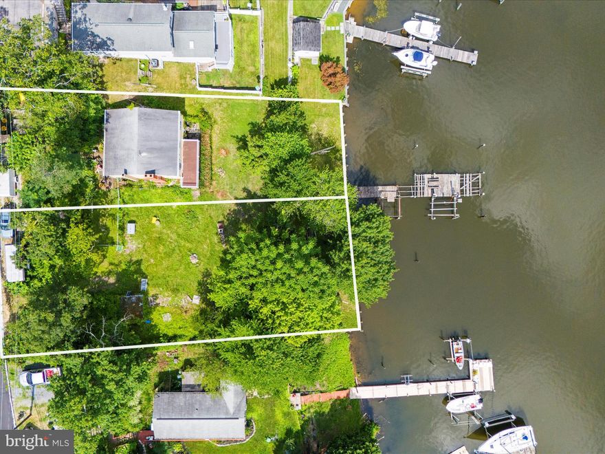 972 & 976 Nabbs Creek Road – Endless Waterfront Potential! Discover the incredible opportunity to own over 120 feet of prime waterfront along beautiful Nabbs Creek! This property includes two parcels (972 & 976) and offers the perfect setting to renovate or build your dream home overlooking the water. The existing home features 2 bedrooms and 2 full bathrooms, with breathtaking views from both upper and lower decks. Inside, you’ll find two charming stone fireplaces, a walk-out basement with large windows, and public water and sewer already connected—a huge advantage for waterfront living. Outside, enjoy direct water access with a private pier in place (in need of repair), ready for you to reimagine into your own ideal boating or fishing retreat.
This home will not qualify for traditional financing and requires cash or a renovation/rehab loan, but the potential is endless. Whether you’re a builder, investor, or dream-home visionary, this is your chance to create something truly special on the water.