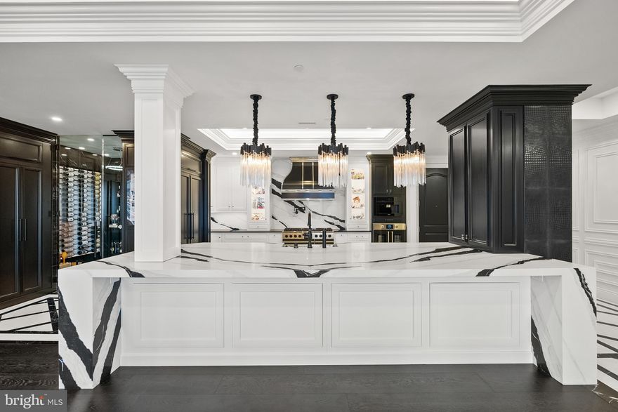 Experience luxury living at its finest in this extraordinary residence that combines two units into one expansive, stunning home in Annapolis Towne Centre offering over 3,400 square feet of impeccably finished living space. Completely gutted to the studs and reimagined, this one-of-a-kind home places you right in the center of it all—and only minutes from Downtown Annapolis—yet feels like a private retreat from the world.

Designed for both grand entertaining and everyday comfort, the custom gourmet kitchen anchors the home and flows seamlessly into inviting living spaces. Sound-proof, glass-tempered doors allow rooms to transition effortlessly from open and connected to intimate and private. Thoughtful details include hidden, built-in Sonos speakers, exquisite moldings, tray ceilings, modern lighting, and a stunning blend of wood and marble flooring throughout.

Wine enthusiasts will appreciate the climate-controlled wine room, while the primary suite is a true sanctuary, featuring a glamorous dressing room, multiple custom closets with secret storage, and a spa-like ensuite bath with hand-cut mosaic tile flooring and an oversized walk-in shower with glass door linen closet. Additional highlights include three additional bedrooms, two additional full baths, high ceilings, and four garage parking spaces.

Residents enjoy world-class amenities including concierge service, fitness center, yoga studio, library, meeting rooms, elegant lounge spaces, and a spectacular rooftop pool—delivering a lifestyle that is as effortless as it is refined.