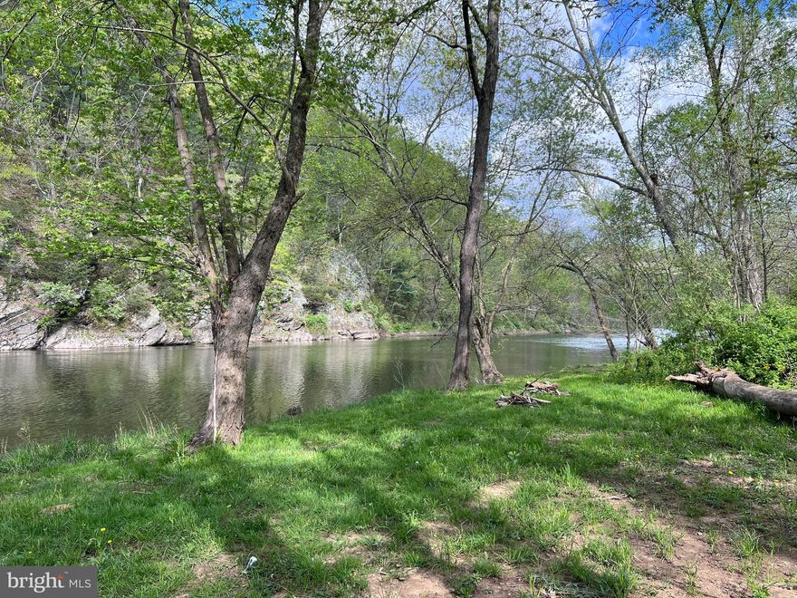 50' of Frontage on the Cacapon River with this tiny cabin out of the flood plain.   Being sold as is and features a well, septic, electric, woodstove and Frontier INTERNET.    Partial  Kitchen, great room and a full bath.    Foam insulated under the cottage, new pressure/holding tank and cover over the well, Seller made a drainage ditch down the hill so now you can drive down to the river from the cabin.   5.19 acres mostly level,  (Lots 1, 19, 20, 21, 22 of Stotler's Sycamore Subdivision).   Enjoying fishing and swimming in this deep watering hole.   Also enjoy kayaking the river to enjoy nature and the beautiful views.   Also you would have use of the common area on the left along Rippling Waters Lane.