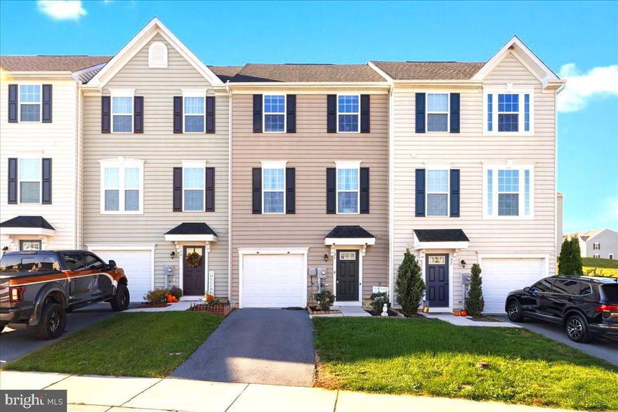 Price Reduction!  This spacious three-level townhome offers modern design, stylish finishes and a location that's hard to beat.  Just a short drive to Maryland and minutes to dining options in Springs Mills, I-81 and the scenic Potomac River.  Step inside to find a convenient half bath and flexible entry level bonus room, perfect for a 4th bedroom, home office, gym or cozy second living area/theatre room.  Upstairs, the open concept main level welcomes you with great natural light, a beautifully-designed living area featuring a custom accent wall and luxury vinyl  plank that ties together the home's coordinated color scheme, and a seamless flow into the dining space and kitchen.  You'll love the massive island, granite countertops, 42-inch cabinetry, stainless steel appliances and complementary finishes that make this space as functional as it is beautiful.  From the dining area, step out to the 16'x12' deck, ideal for morning coffee, weekend grilling and entertaining.  The upper level features two comfortable bedrooms, a full bath and a convenient laundry area.  Retreat to your primary suite with tray ceiling, walk-in closet and a private bath featuring dual vanities and a walk-in shower.  The HVAC system includes a whole-house humidifier for year-round comfort and the one car garage is an added bonus for convenience/storage in this thoughtfully-designed home.  
If you've been searching for a move-in ready townhome with great space, natural light and easy access/convenience to everything Falling Waters has to offer, this one checks every box!