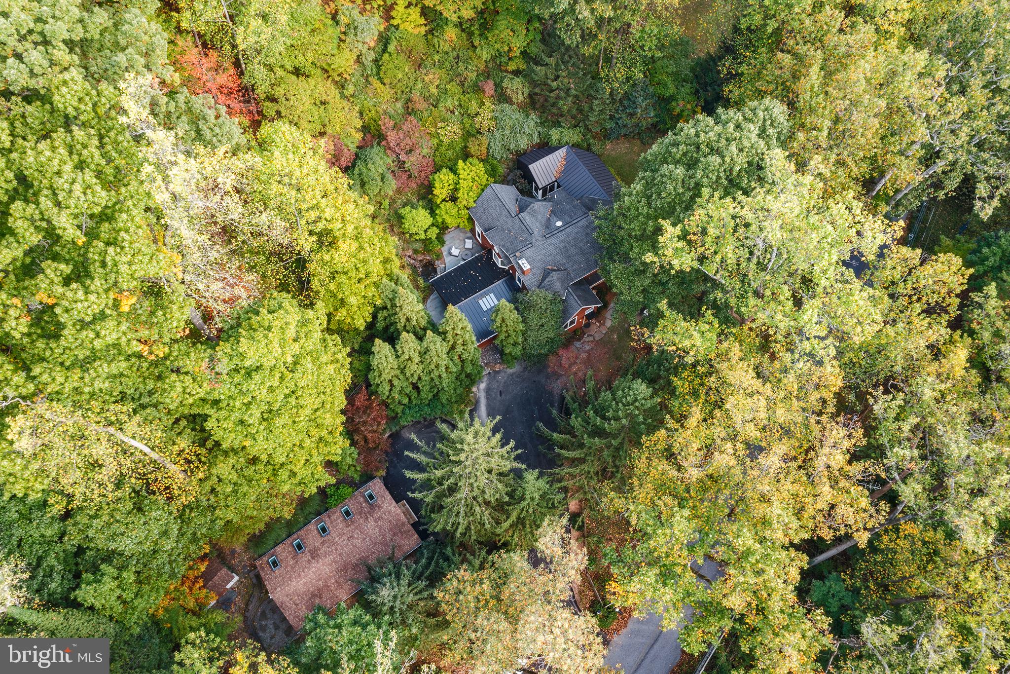 This remarkable 2.66-acre hideaway offers complete privacy while being just minutes from the heart of Wayne, King of Prussia Mall, and major highways like 202, 476, and 76. The open floor plan is designed to impress with soaring ceilings, walls of windows, and breathtaking expansive views.
As you enter, the 2-story foyer welcomes you into a grand living space that includes a spacious family room with a vaulted ceiling and abundant natural light, a formal dining room with a fireplace, and a newly remodeled kitchen featuring custom cabinetry and professional-grade built-in appliances. Adjacent to the kitchen is a bright breakfast room with sliding glass doors leading to a magnificent patio, lush landscaping, and a tranquil pond with a waterfall.
The main level also features a full bathroom, a half bath, and three bedrooms, one of which is oversized and boasts custom-built cabinetry, making it ideal for use as a family room, media room, library, or bonus space.
On the upper level, you'll discover a romantic loft with a 3-sided gas fireplace that overlooks the living areas below and offers stunning treetop views. This level also includes a luxurious master suite with a walk-in closet, private balcony, and an en suite bathroom featuring a soaking tub and separate shower.
The lower level exudes warmth with its exposed stone wall and cozy powder room. It’s a great place to hang out.
Additionally, the property features a separate, versatile building—perfect for an office, studio, or gym. With high ceilings, wood floors, skylights, sliding glass doors, and independent electric service, this space offers endless possibilities.